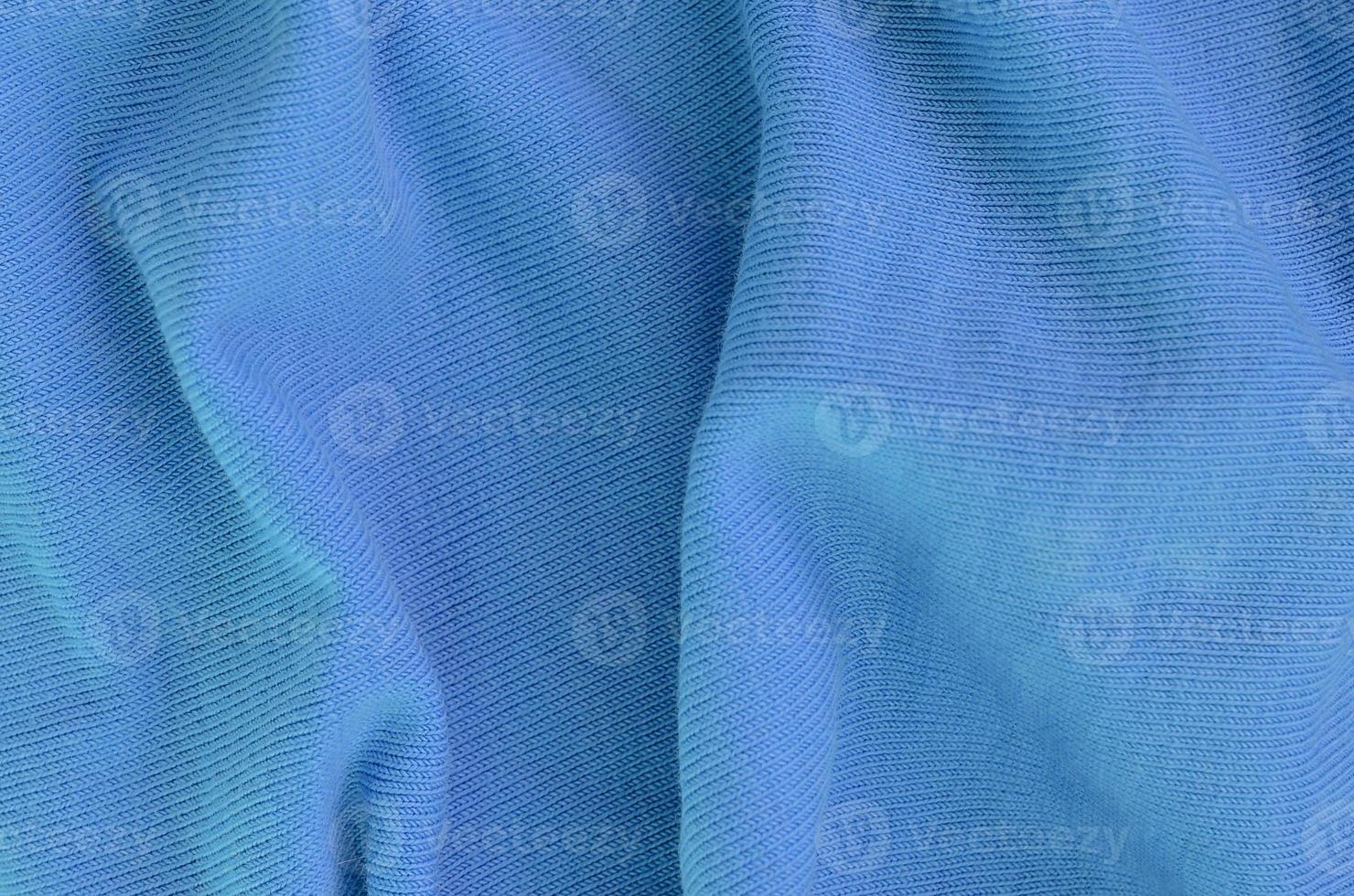 The texture of the fabric in blue color. Material for making shirts and blouses photo