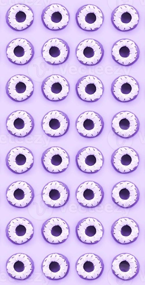 Many small plastic donuts lies on a pastel colorful background. Flat lay minimal pattern. Top view photo