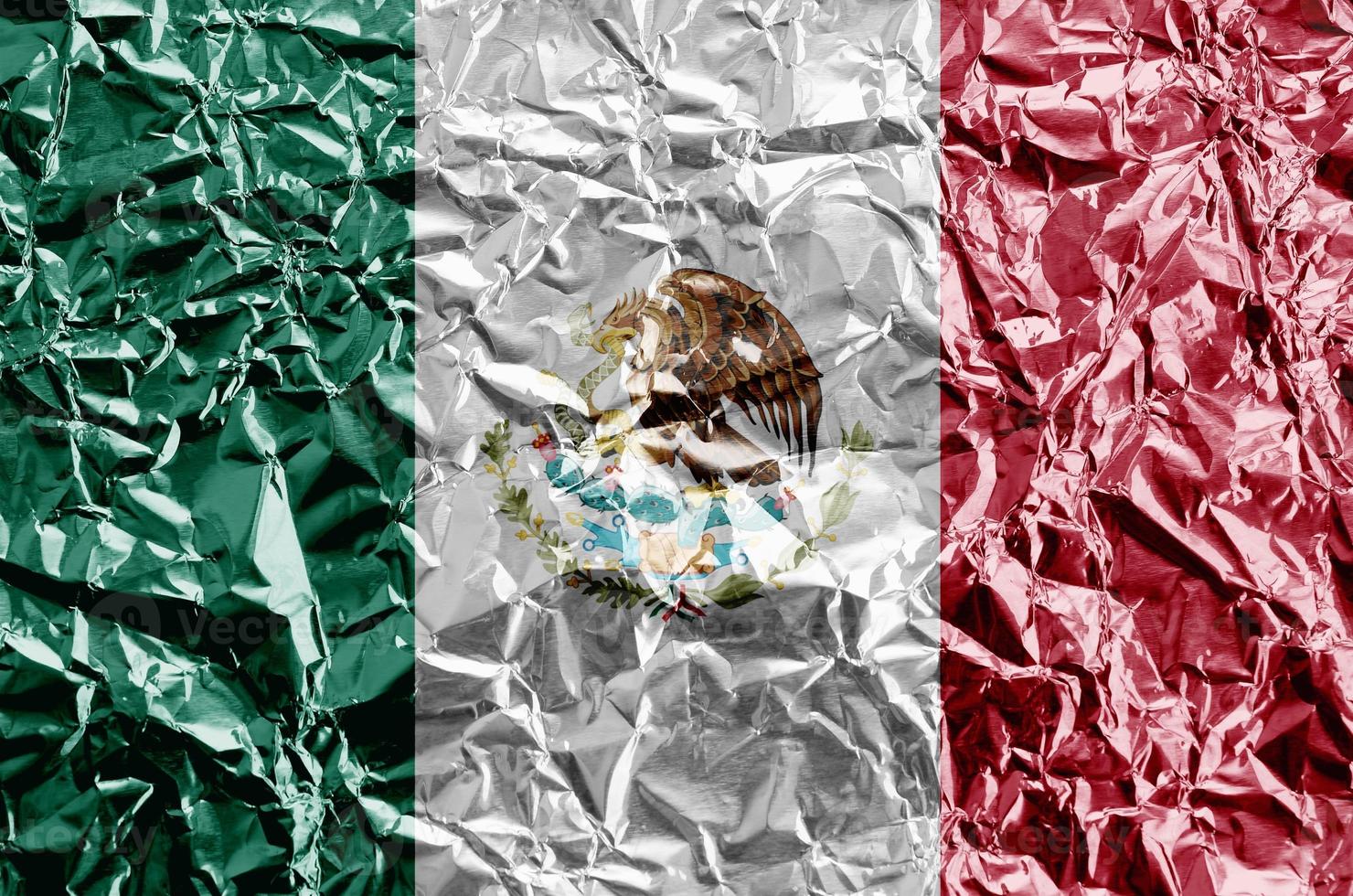 Mexico flag depicted in paint colors on shiny crumpled aluminium foil closeup. Textured banner on rough background photo