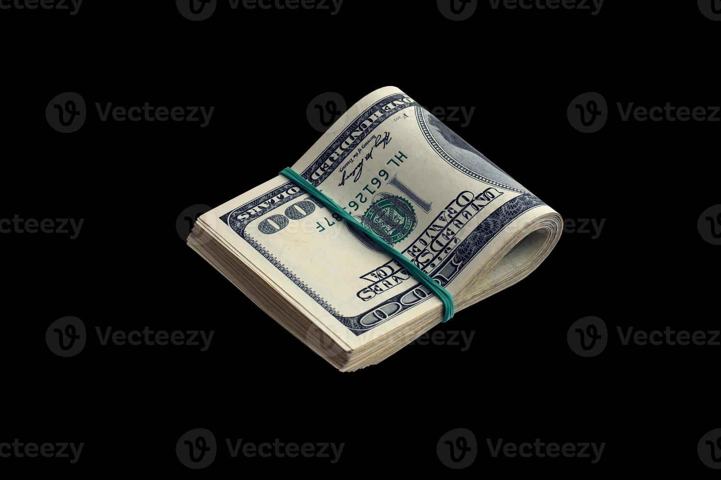 Bundle of US dollar bills isolated on black. Pack of american money with high resolution on perfect black background photo
