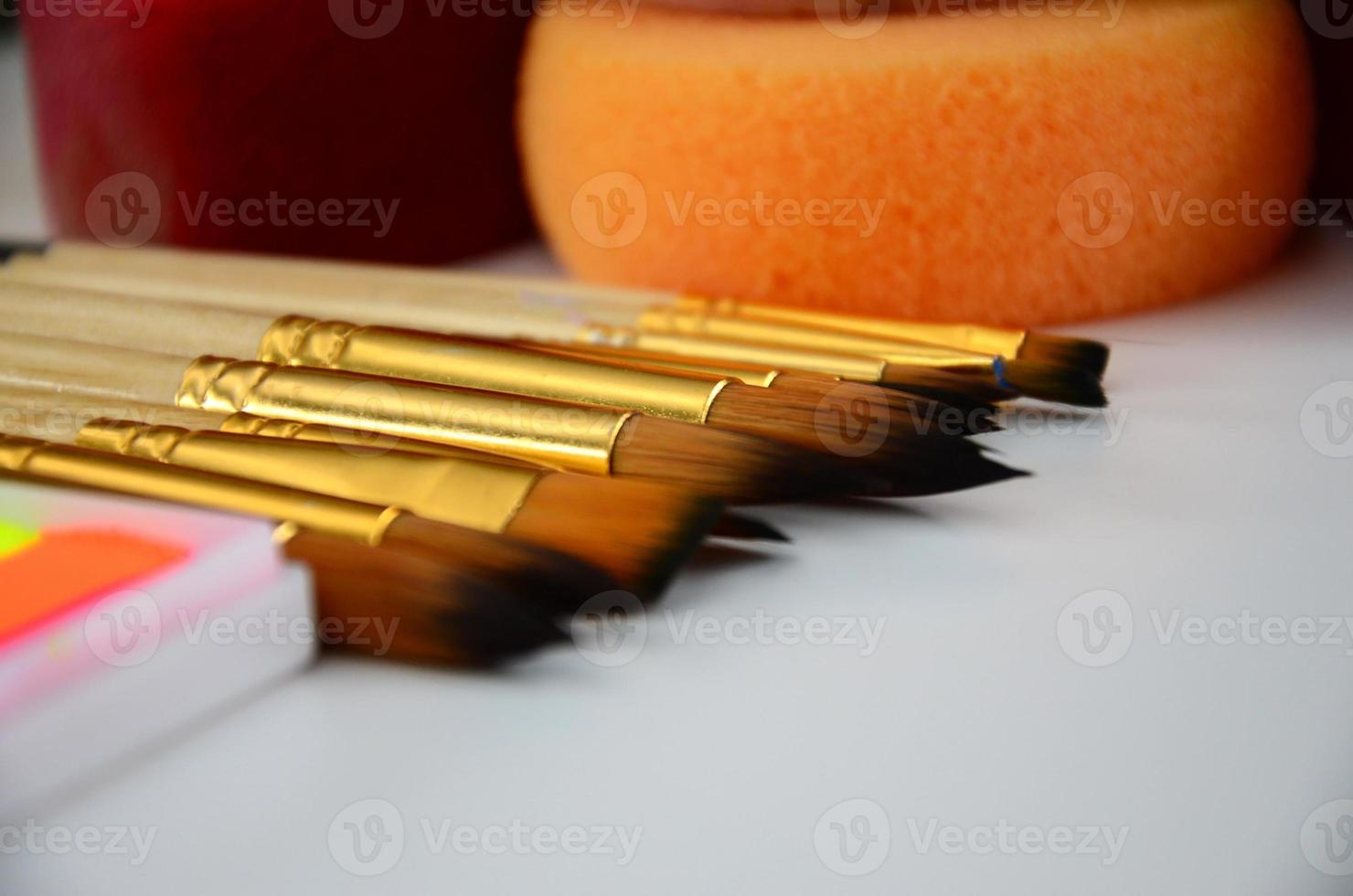 Color cosmetics, brushes and sponges for face painting on white background photo
