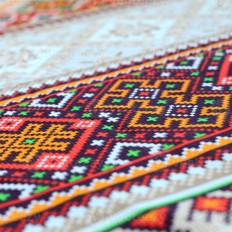 Traditional Ukrainian folk art knitted embroidery pattern on textile fabric photo