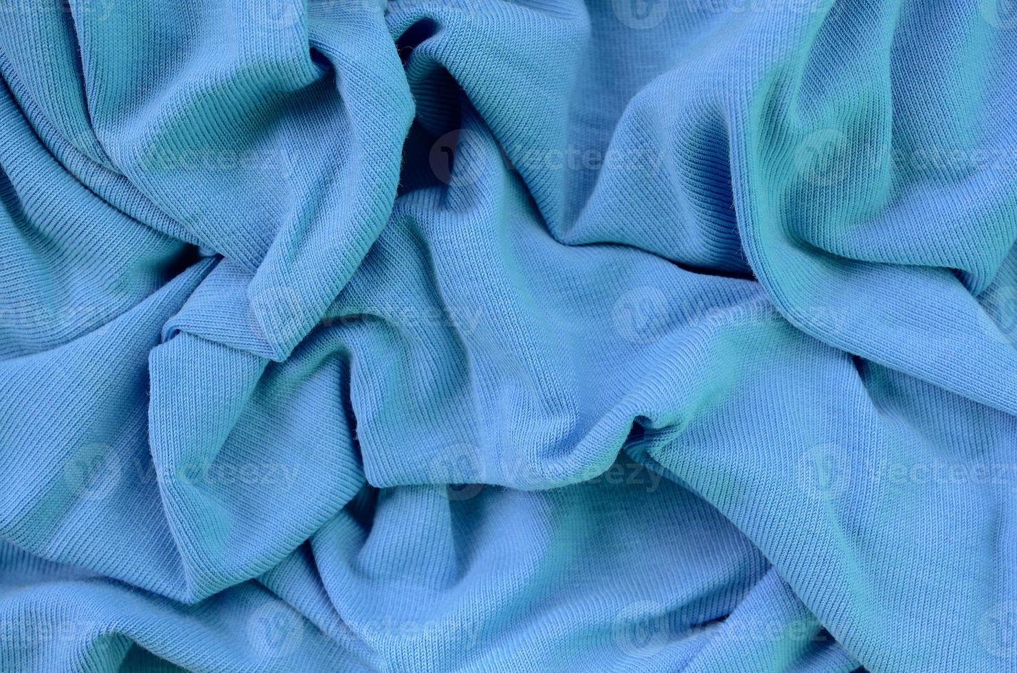 The texture of the fabric in blue color. Material for making shirts and blouses photo