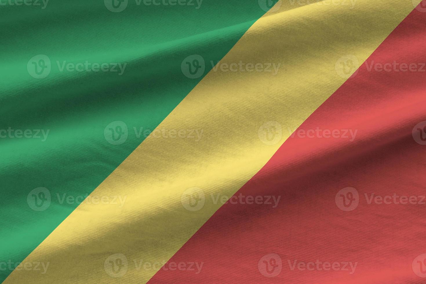 Congo flag with big folds waving close up under the studio light indoors. The official symbols and colors in banner photo