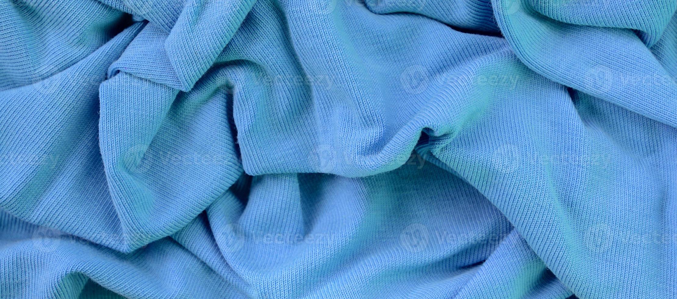 The texture of the fabric in blue color. Material for making shirts and blouses photo