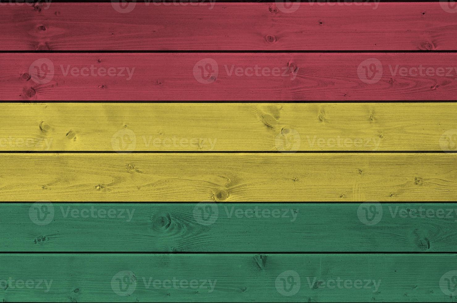 Bolivia flag depicted in bright paint colors on old wooden wall. Textured banner on rough background photo