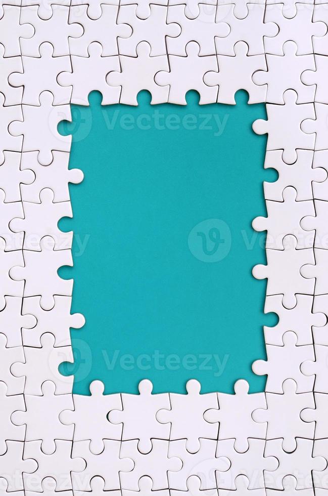 Framing in the form of a rectangle, made of a white jigsaw puzzle around the blue space photo