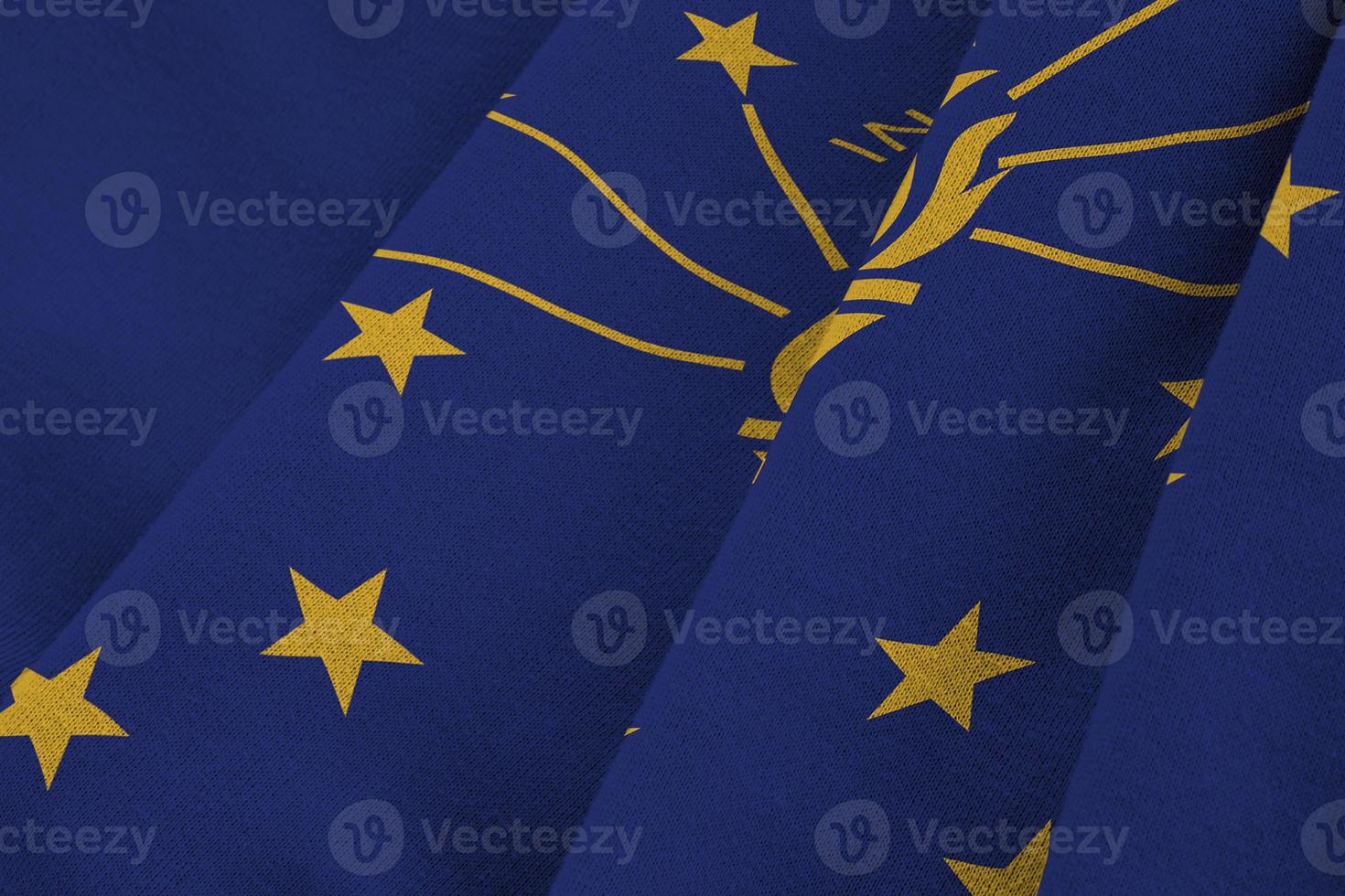 Indiana US state flag with big folds waving close up under the studio light indoors. The official symbols and colors in banner photo