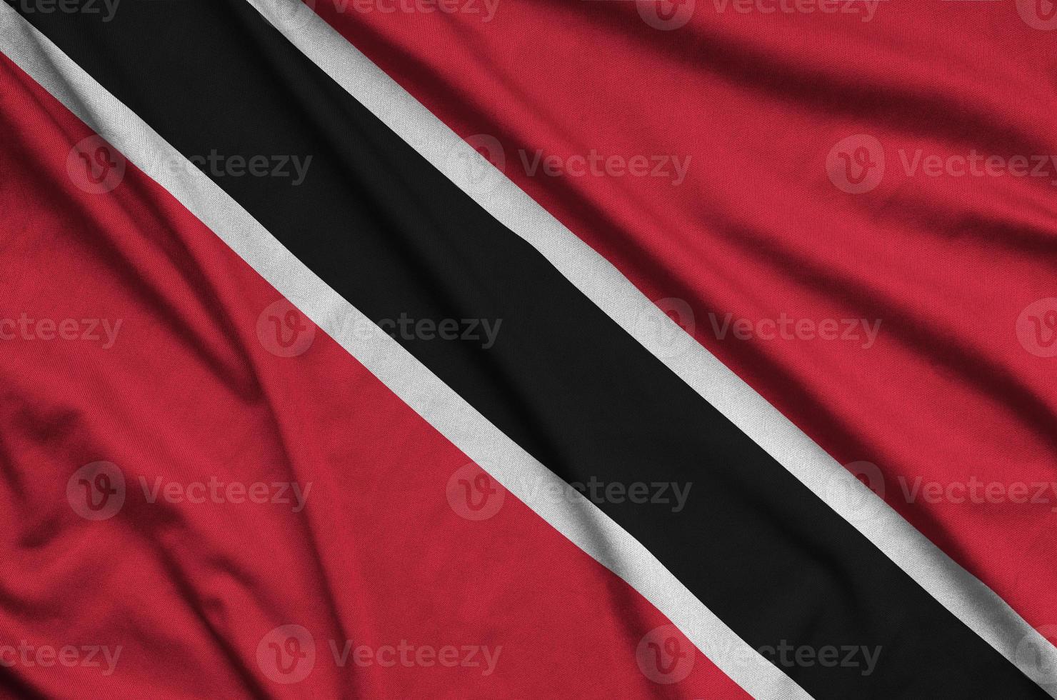 Trinidad and Tobago flag  is depicted on a sports cloth fabric with many folds. Sport team banner photo