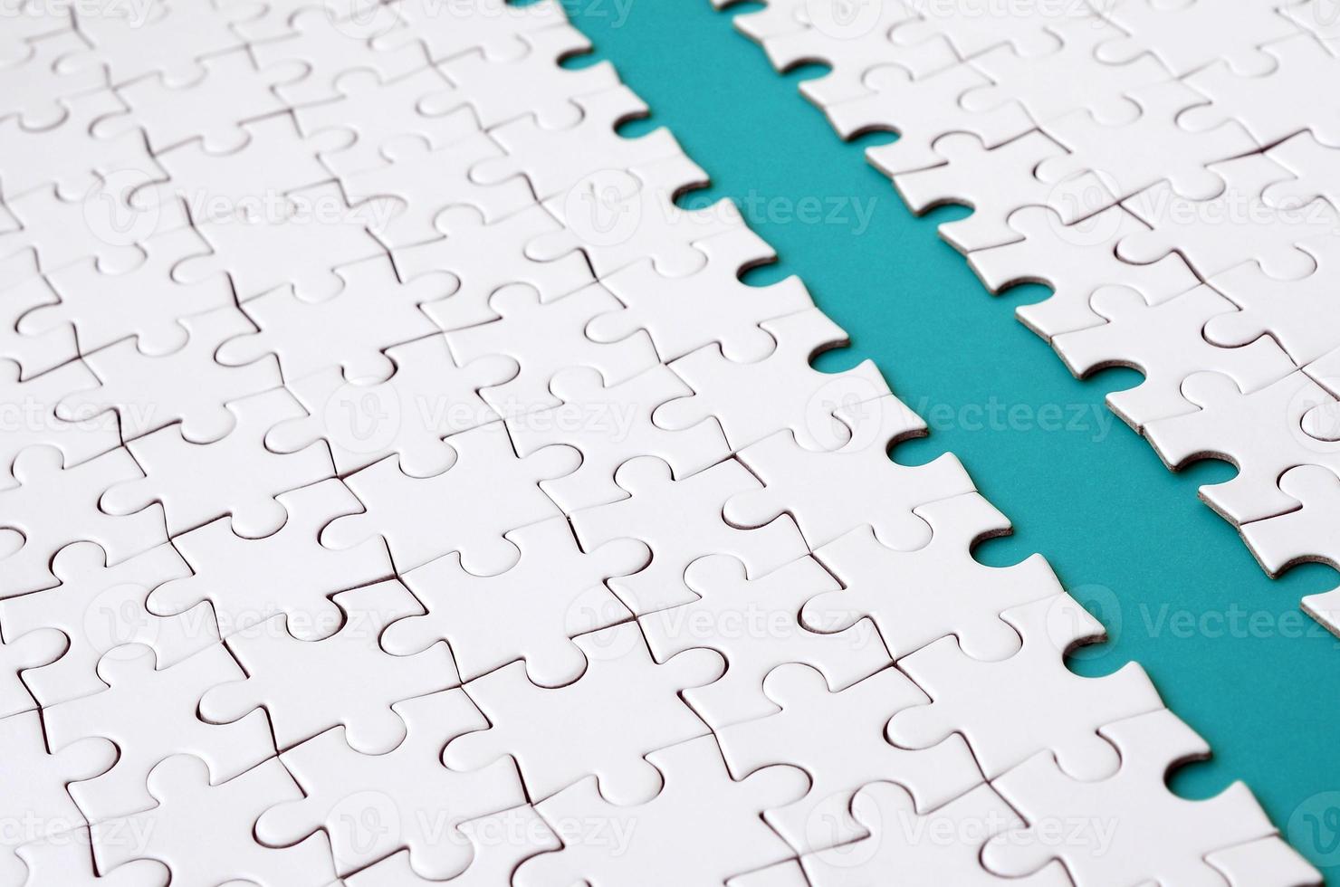The blue path is laid on the platform of a white folded jigsaw puzzle. Texture image with copy space for text photo