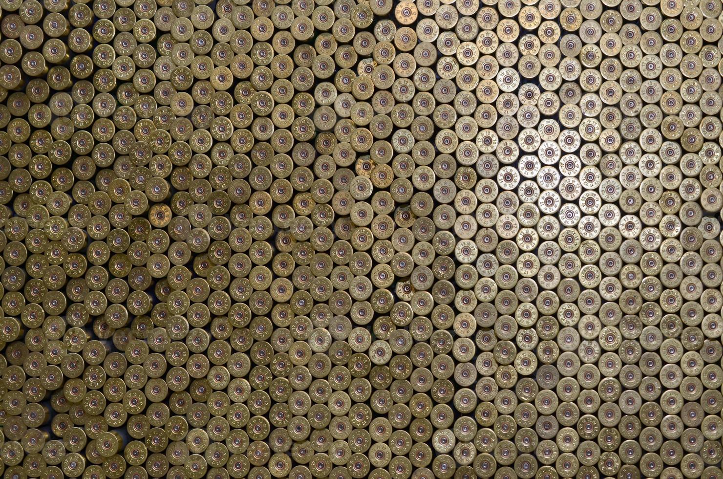 Pattern of 12 gauge cartridges for shotgun bullets. Shells for hunting rifle close up. Backdrop for shooting range or ammunition trade concepts photo