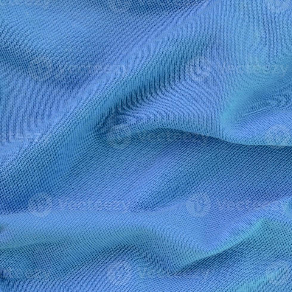 The texture of the fabric in blue color. Material for making shirts and blouses photo