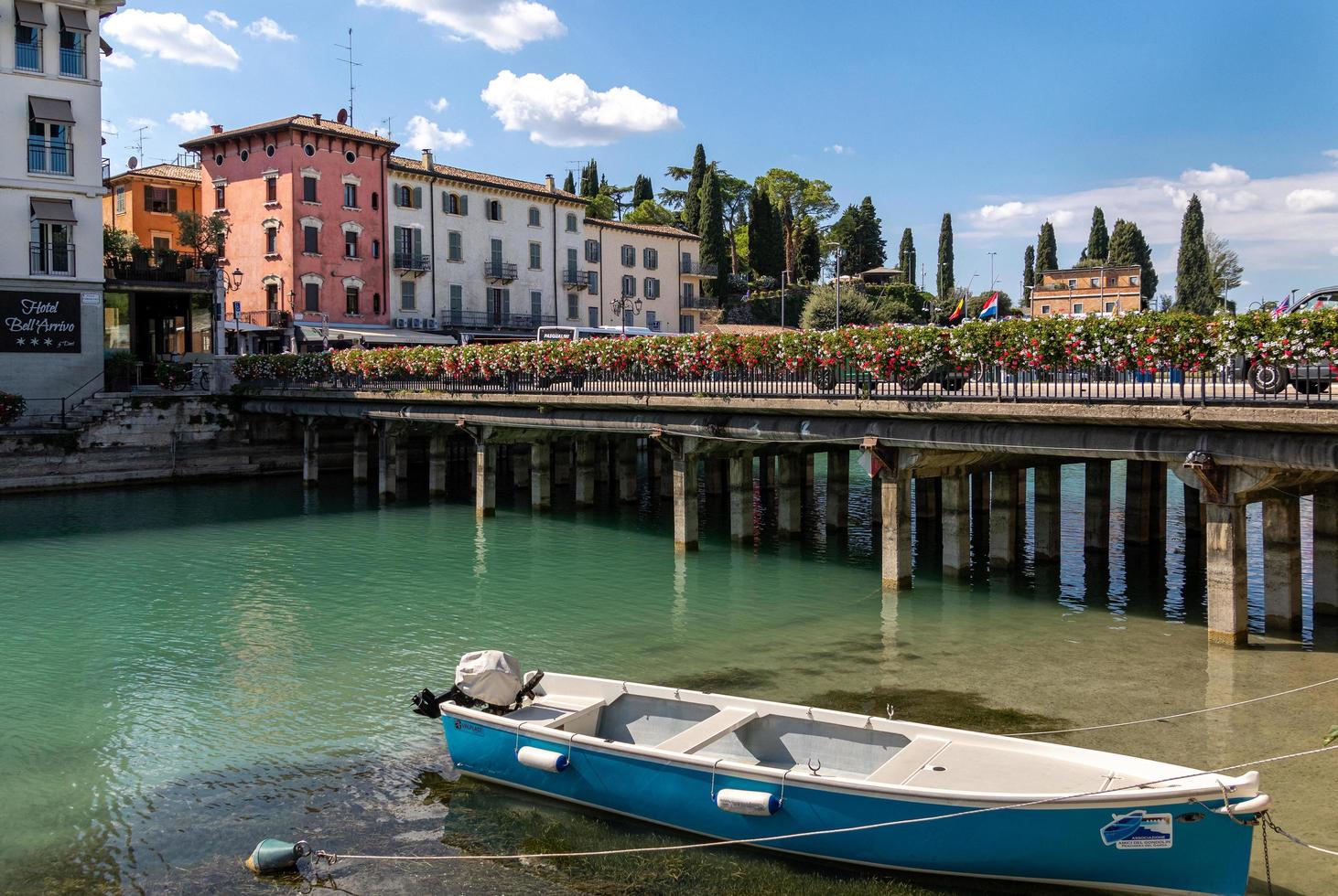 Peschiera del Garda, Verona, Italy - 22 September 2022 Beautiful cityscape with houses and boats at Canale di mezzo at Peschiera, Lago del Garda photo