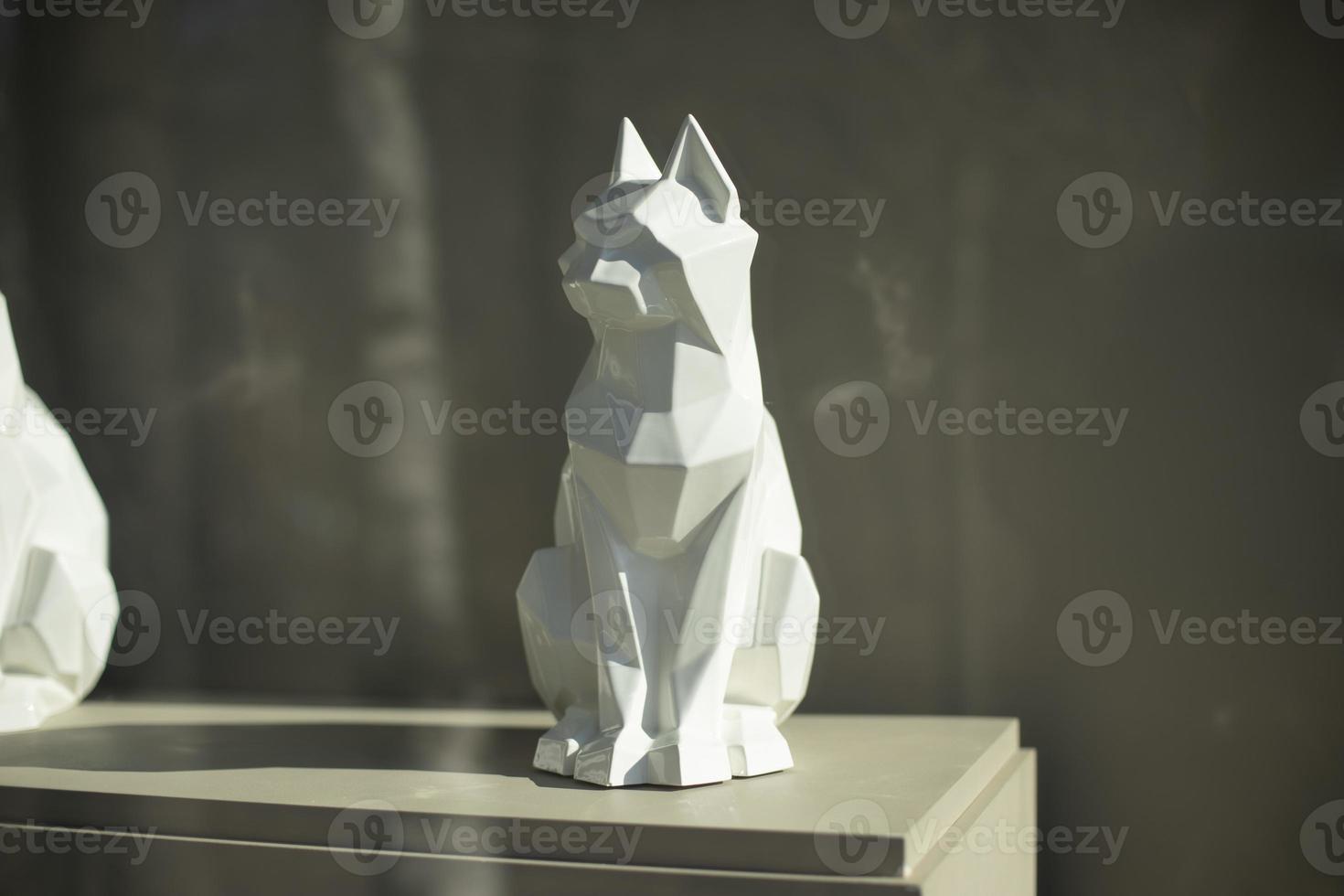 Figure of cat. Sculpture made of white plastic. Interior details. photo
