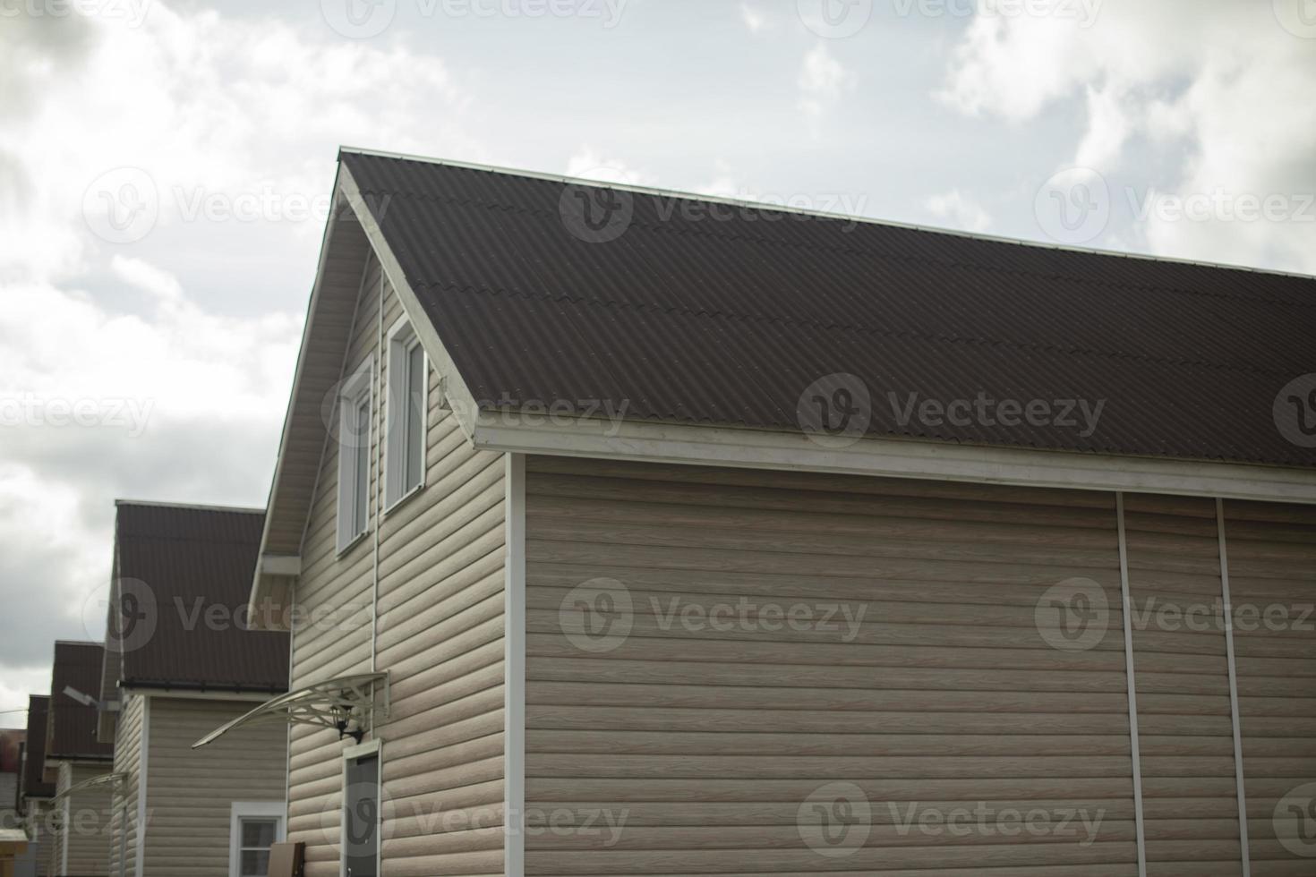 Country houses stand in row. Simple houses for living in countryside. Private accommodation. photo