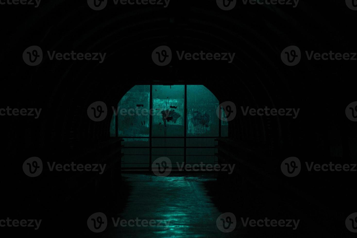 Dark tunnel in the dark. Light at the end of the transition. Place in the city without lighting. photo