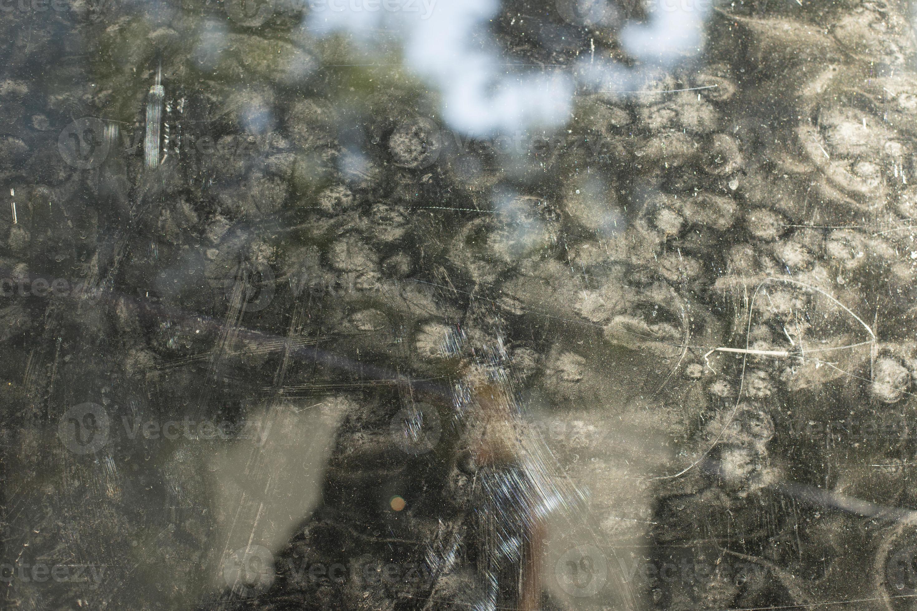 Dirty mirror on street. Reflection in turbid glass. Prints on surface