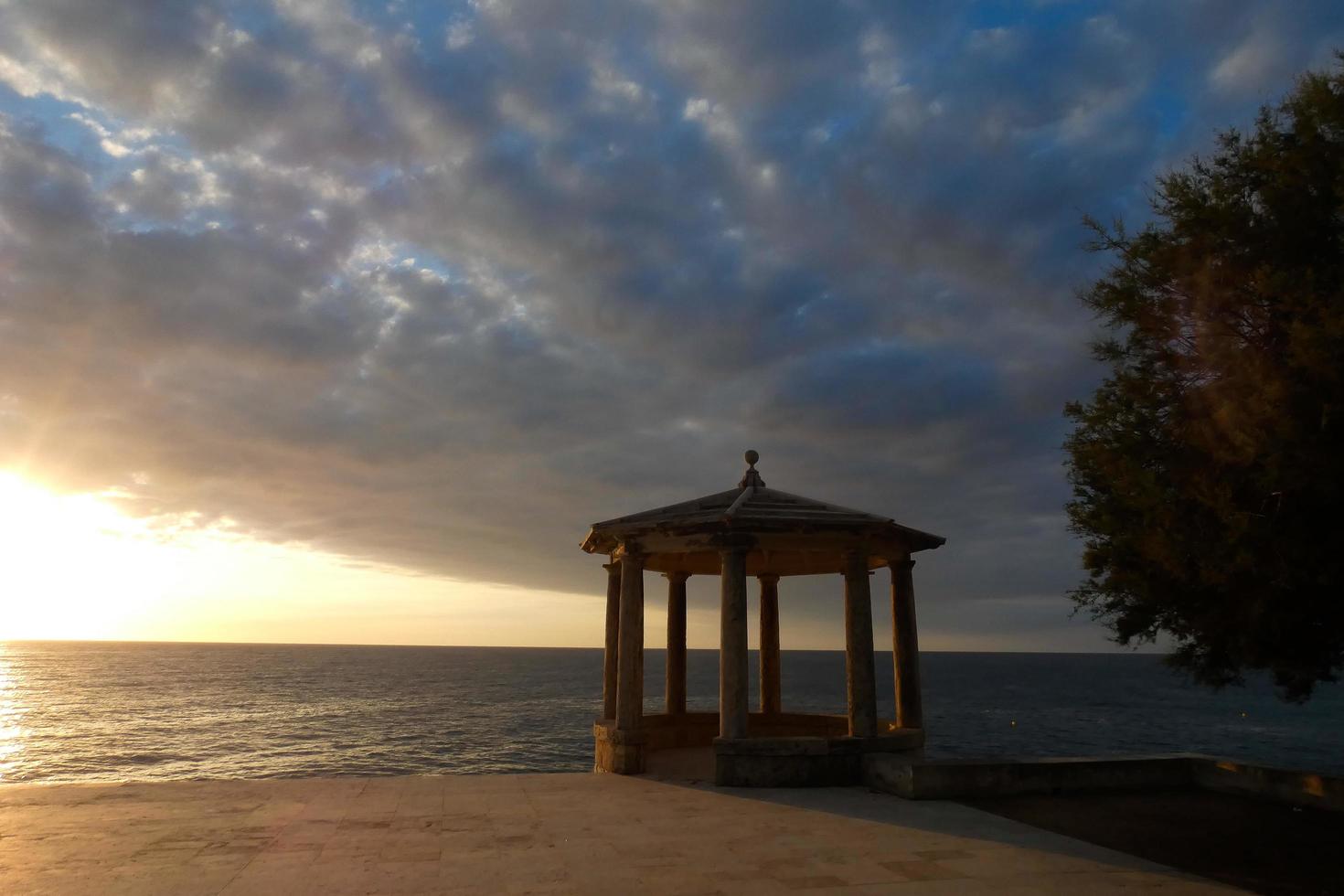 stone gazebo in front of the sea photo