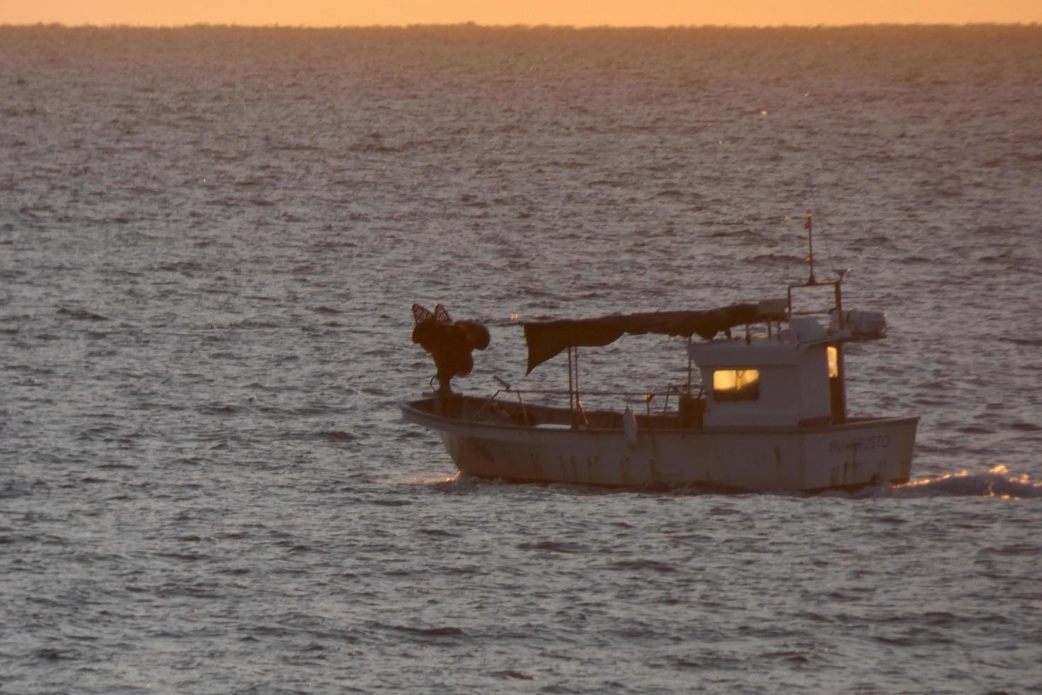 Fishermen returning from fishing at dawn after spending the whole night at sea. photo