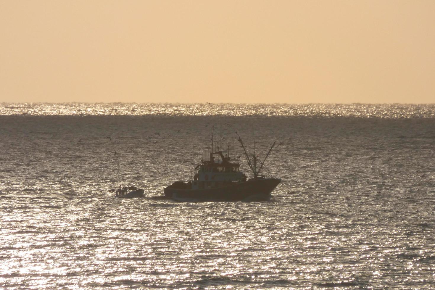 Fishermen returning from fishing at dawn after spending the whole night at sea. photo