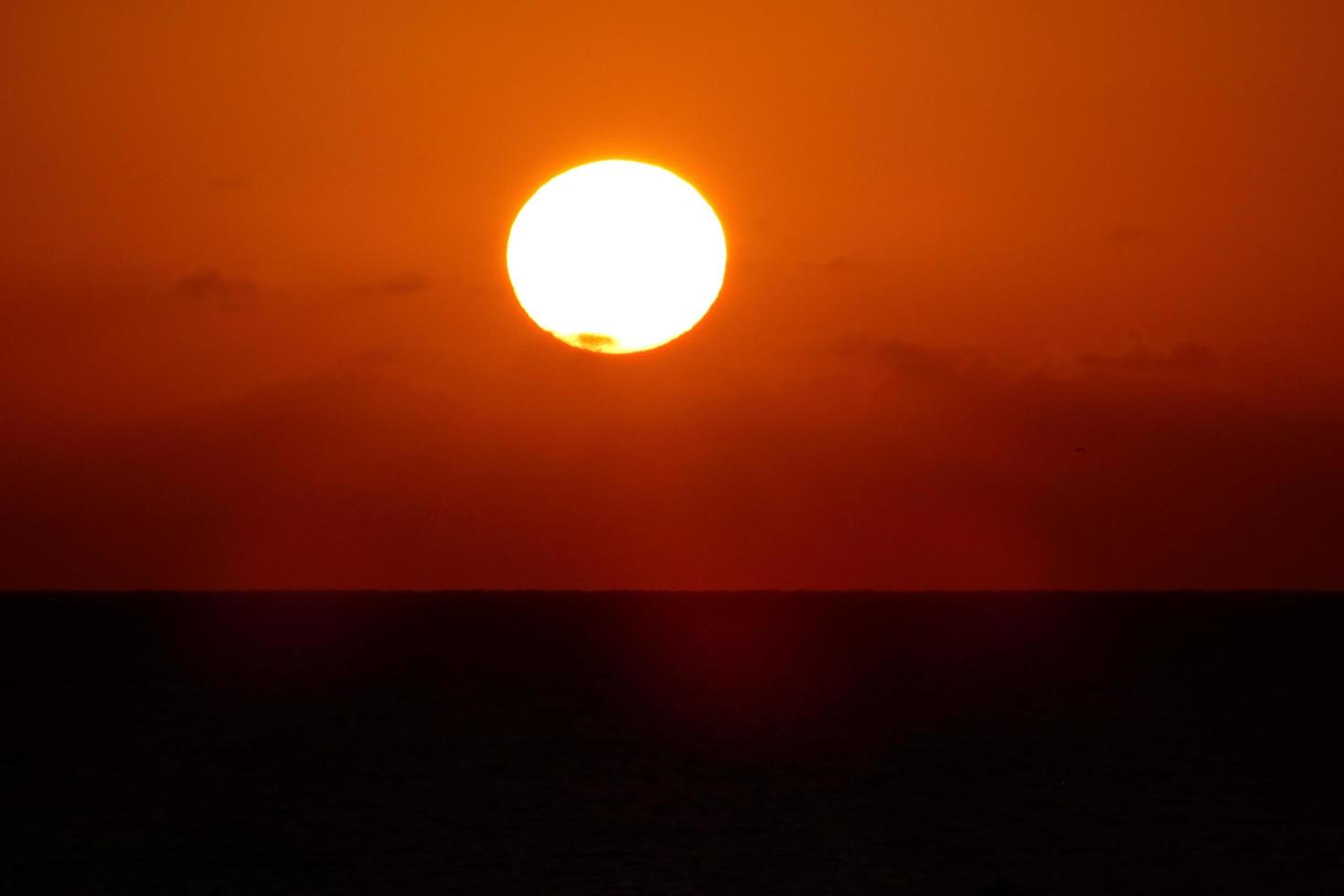 Sun disk rising over the horizon of the sea, sunrise, dawn photo