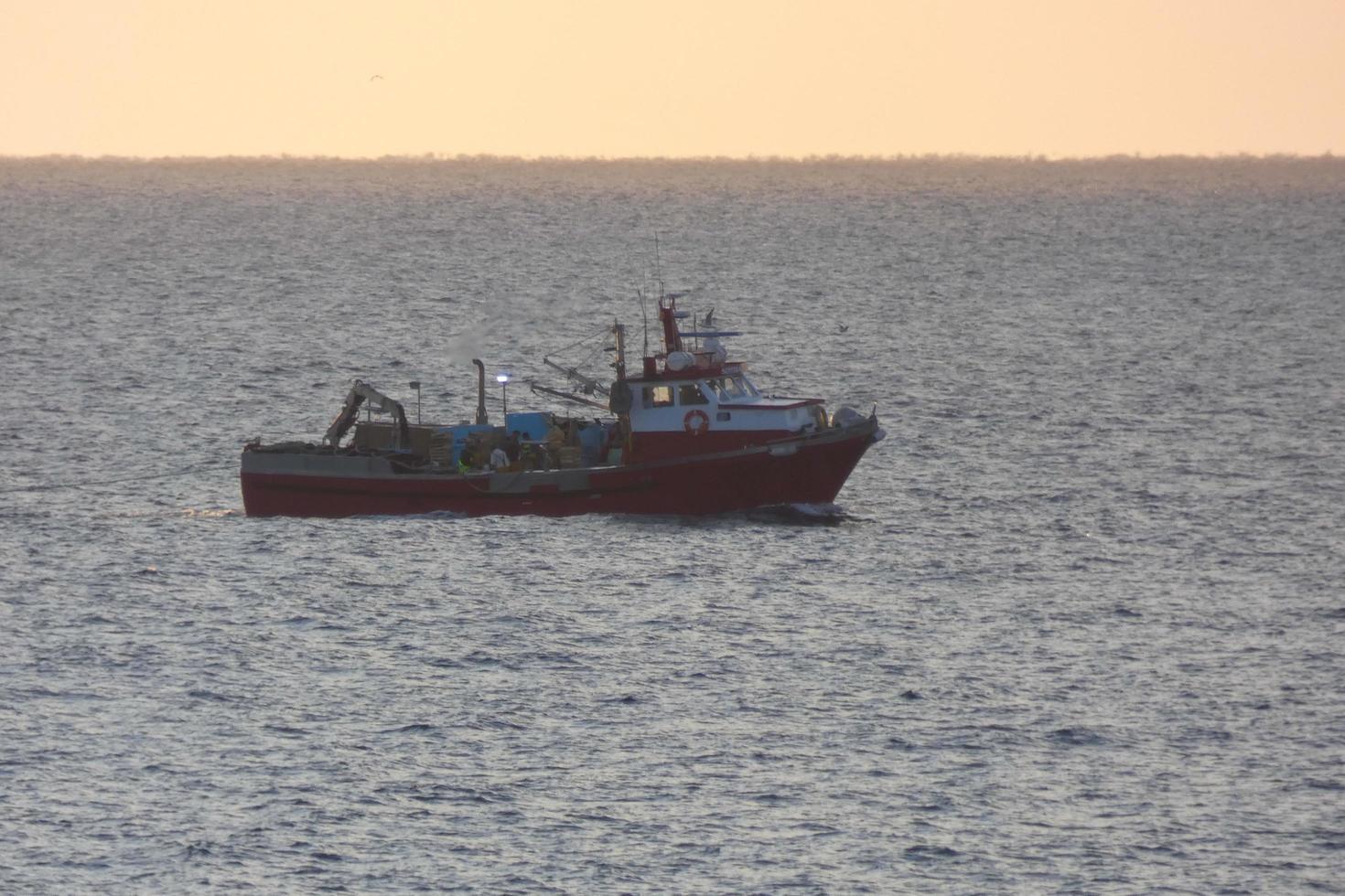 Fishermen returning from fishing at dawn after spending the whole night at sea. photo