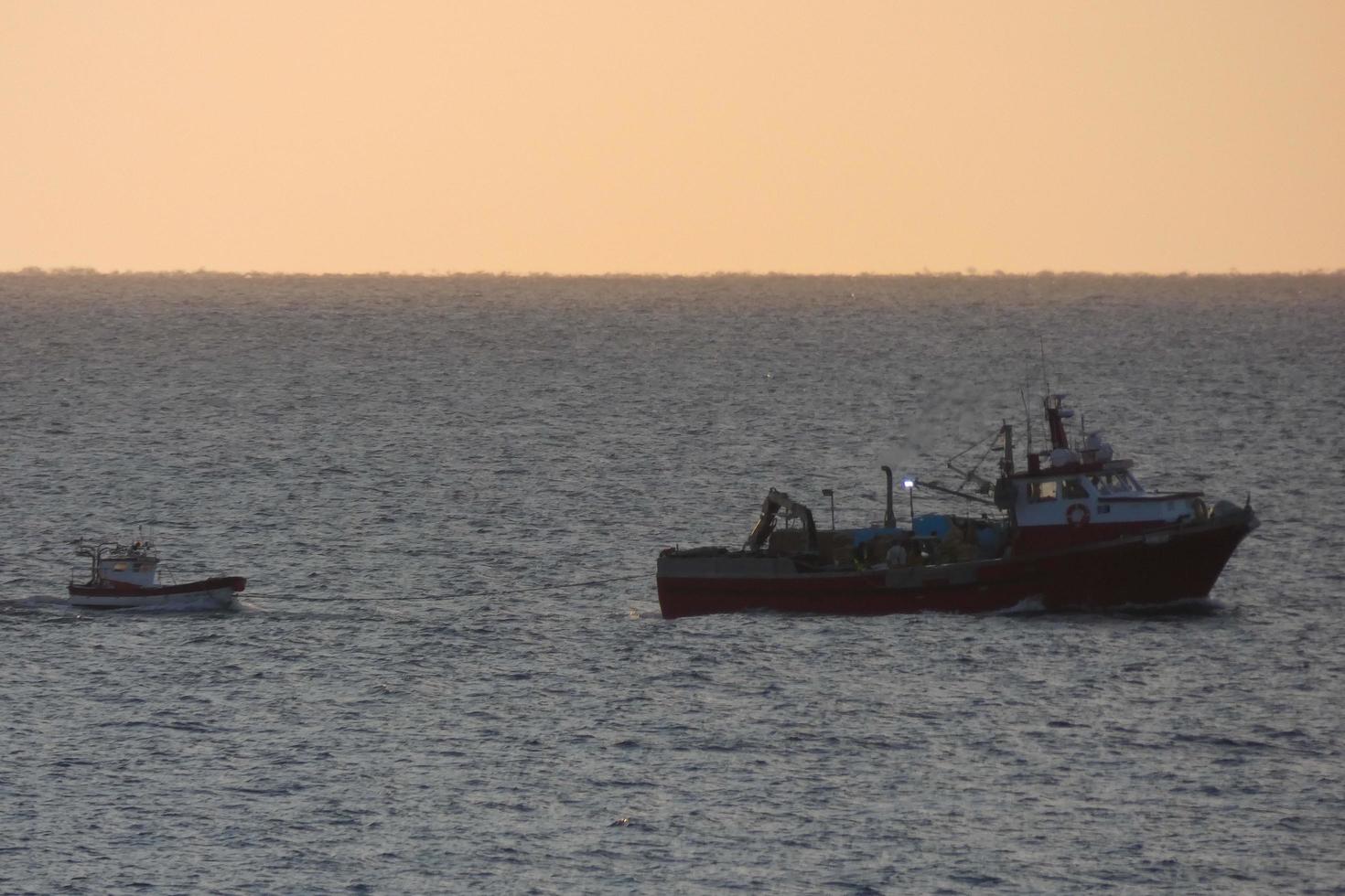 Fishermen returning from fishing at dawn after spending the whole night at sea. photo