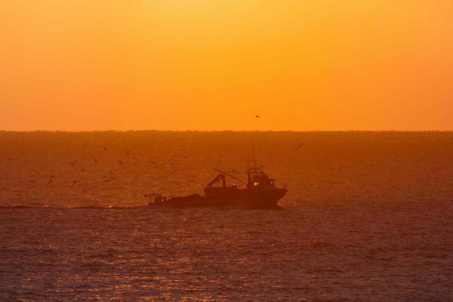 Fishermen returning from fishing at dawn after spending the whole night at sea. photo