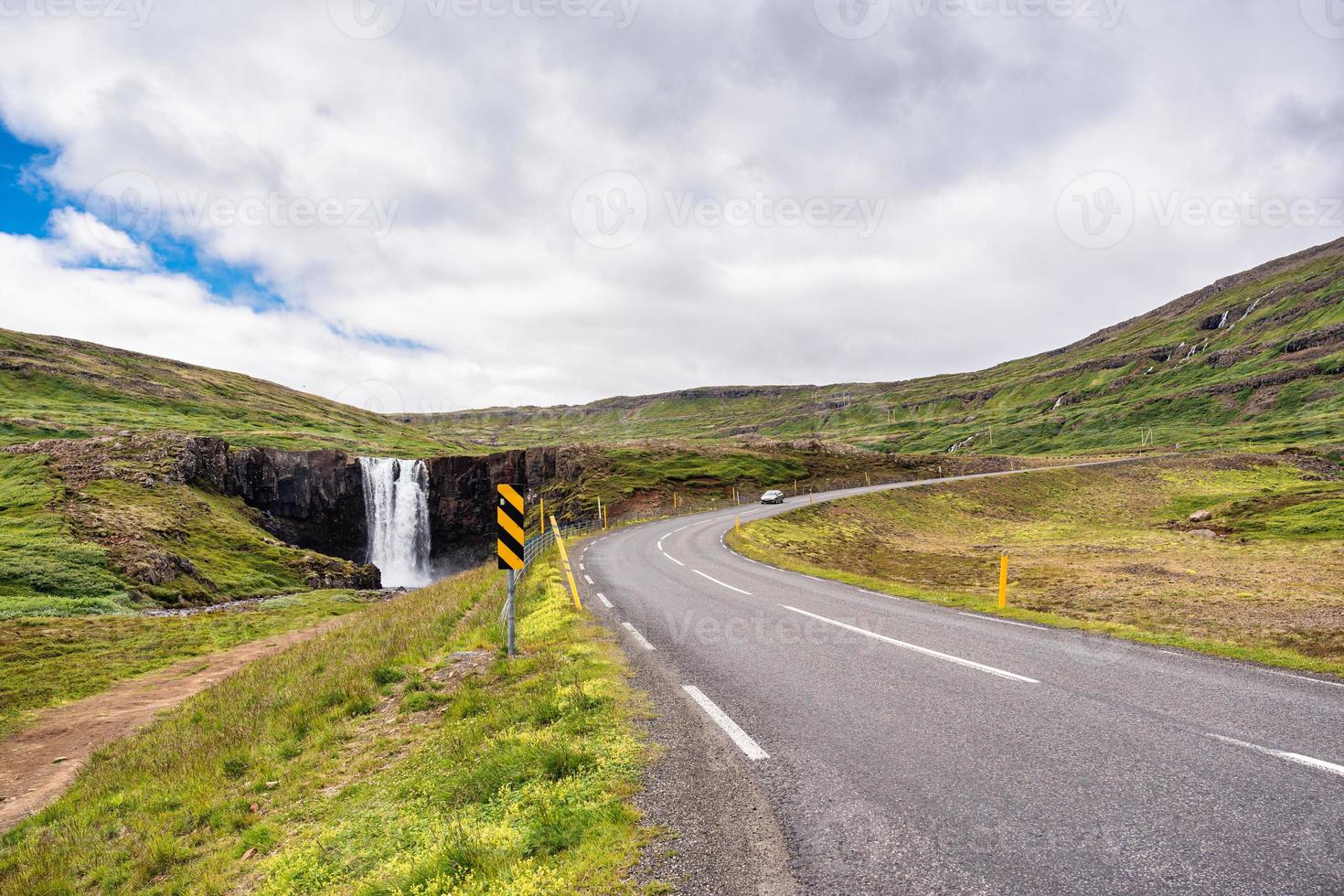 Gufufoss waterfall and car driving on highway in Fjord on summer at Iceland photo