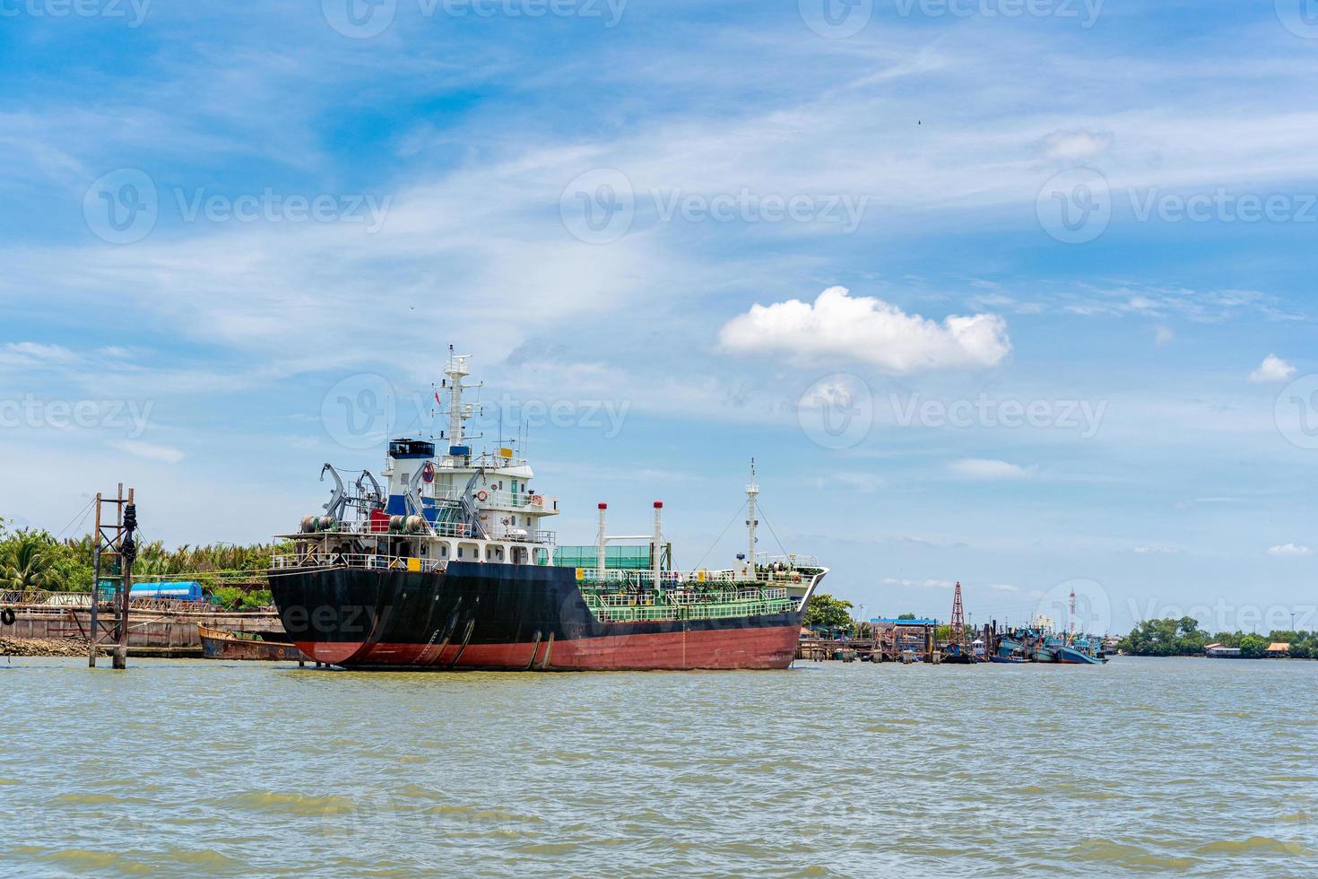 Cargo freight ship moored at import and export port to load industrial goods photo
