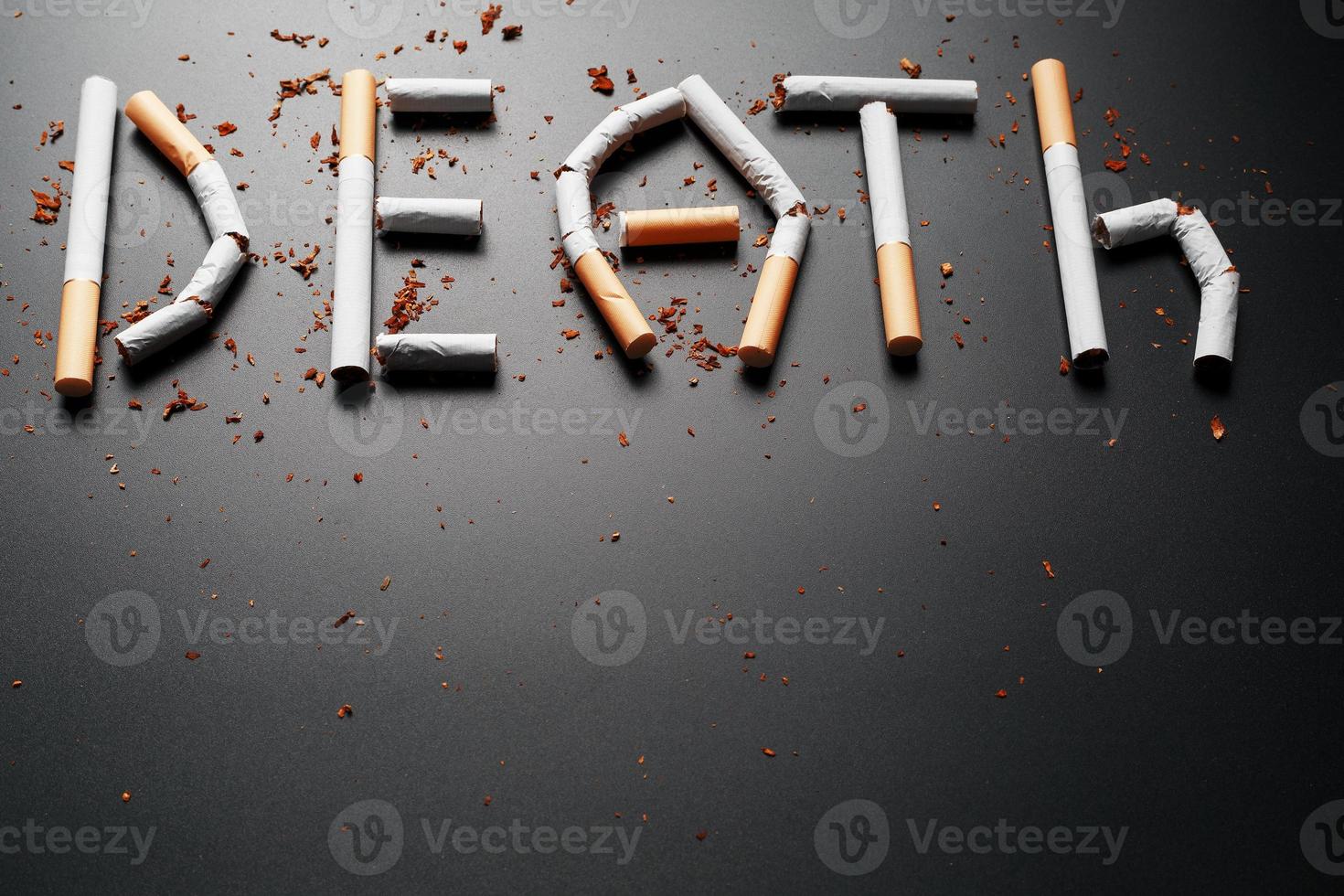 The inscription DEATH from cigarettes on a black background. Stop smoking. The concept of smoking kills. Motivation inscription to quit smoking, unhealthy habit. photo