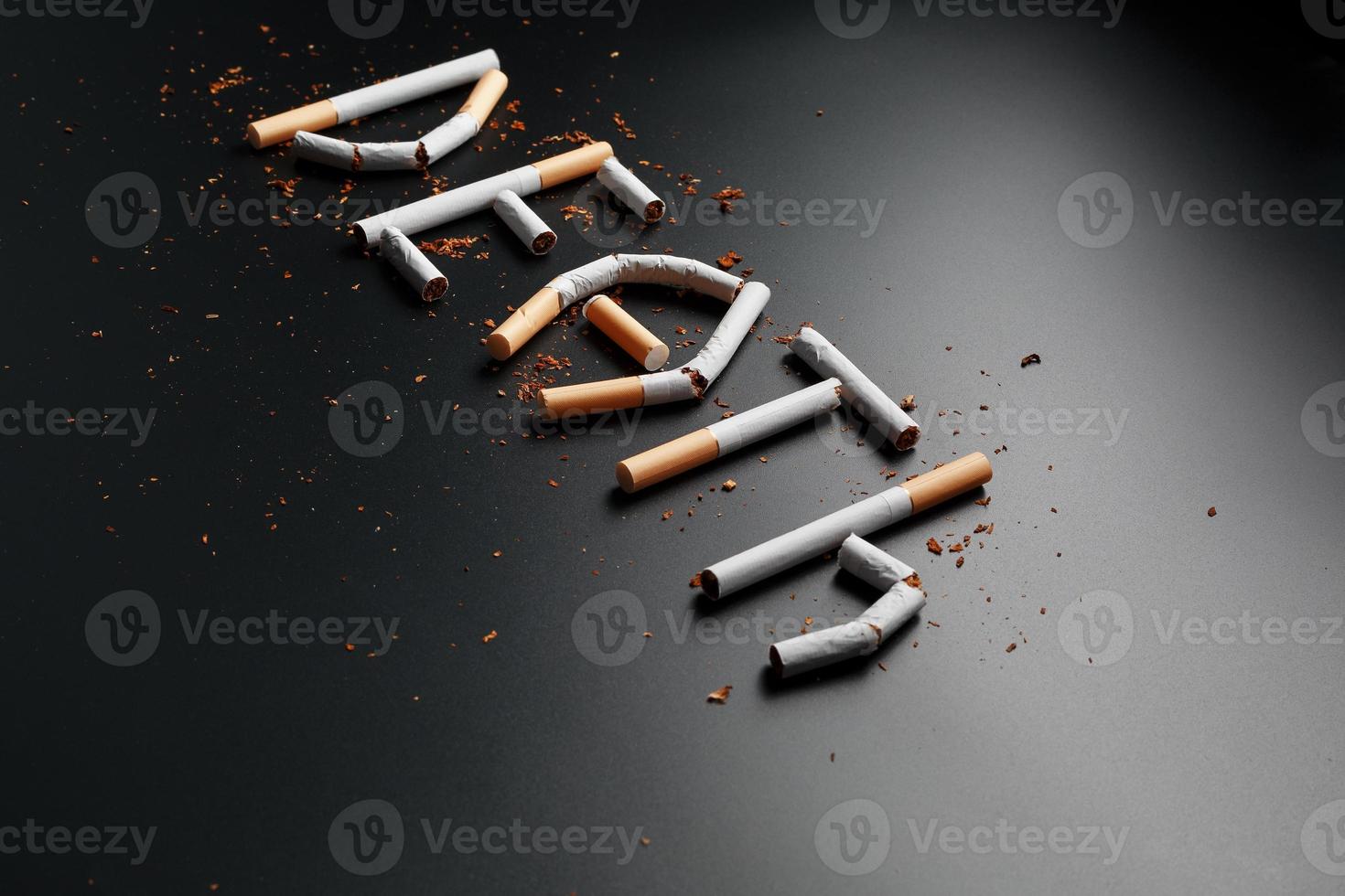 The inscription DEATH from cigarettes on a black background. Stop smoking. The concept of smoking kills. Motivation inscription to quit smoking, unhealthy habit. photo