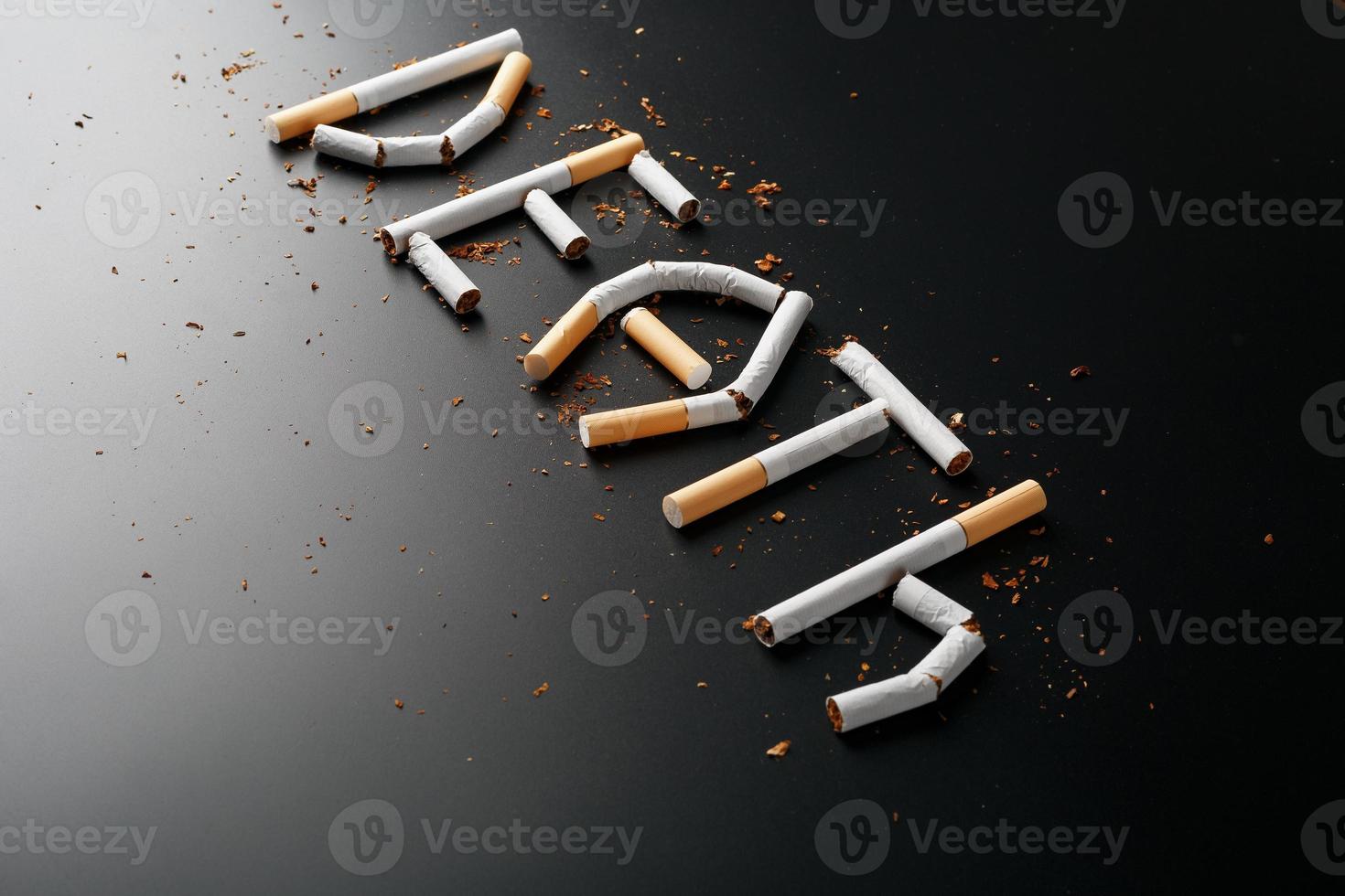 The inscription DEATH from cigarettes on a black background. Stop smoking. The concept of smoking kills. Motivation inscription to quit smoking, unhealthy habit. photo