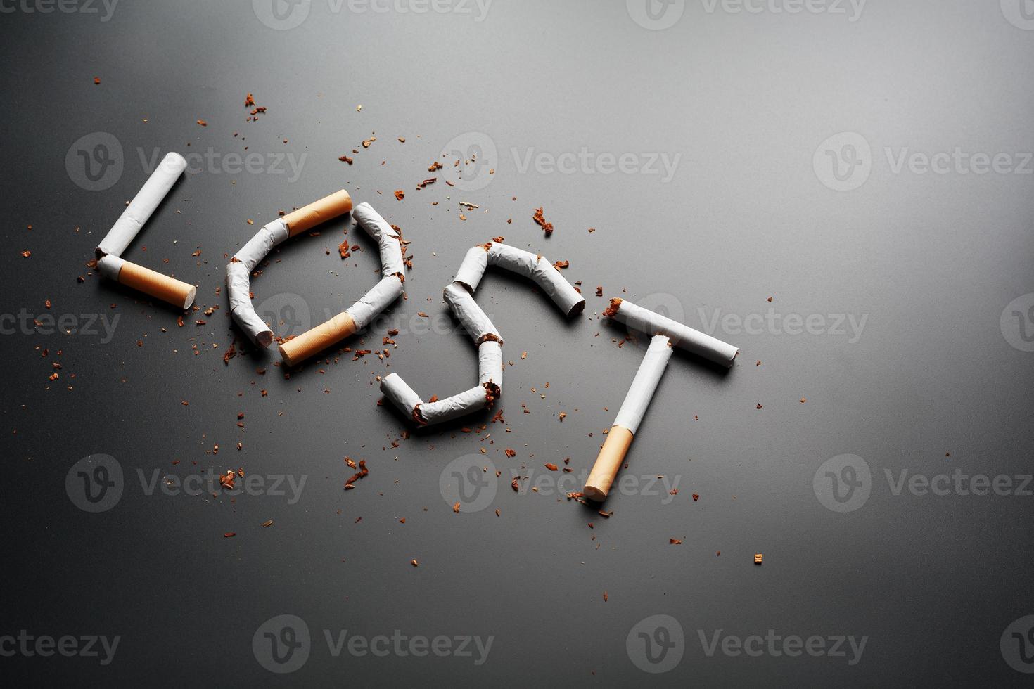 The inscription LOST from cigarettes on a black background. Stop smoking. The concept of smoking kills. Motivation inscription to quit smoking, unhealthy habit. photo