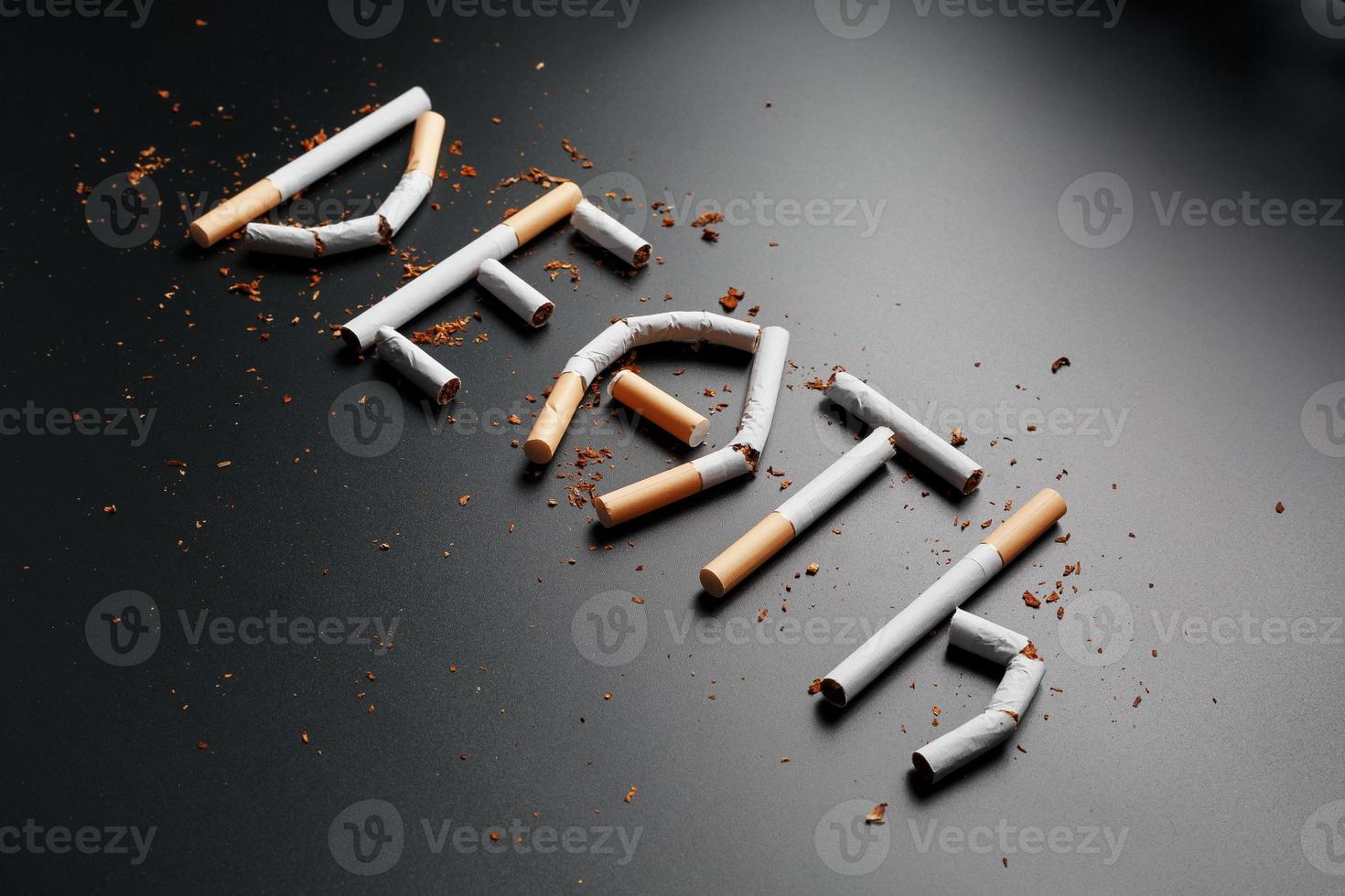 The inscription DEATH from cigarettes on a black background. Stop smoking. The concept of smoking kills. Motivation inscription to quit smoking, unhealthy habit. photo