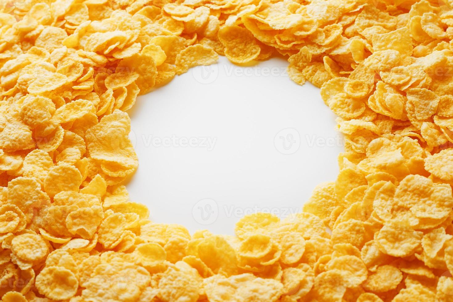 Golden Cornflakes full frame with empty round copy space in the middle as viewed from above photo