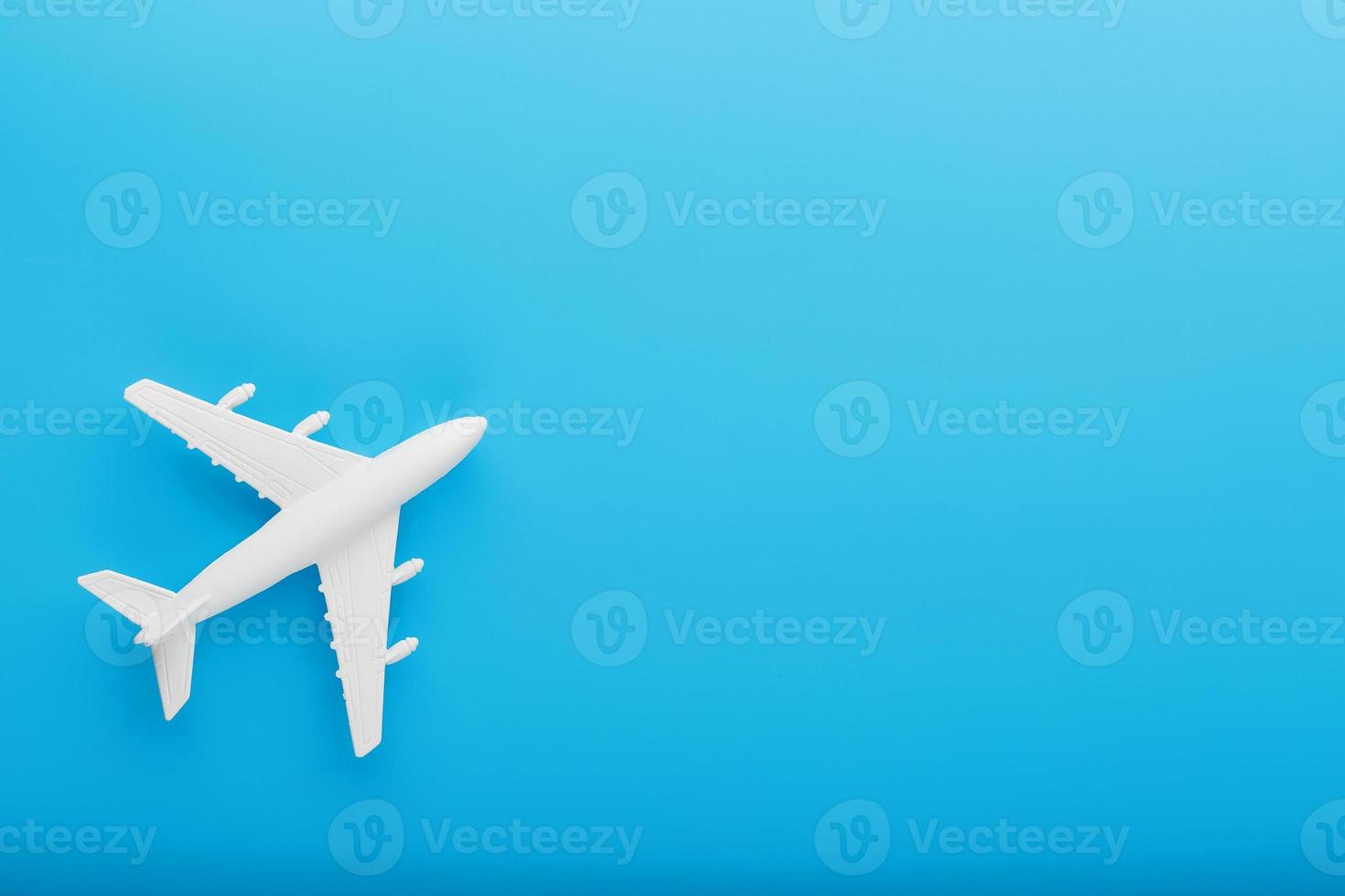 Passenger Model airplane on a blue background. Free space for text. photo