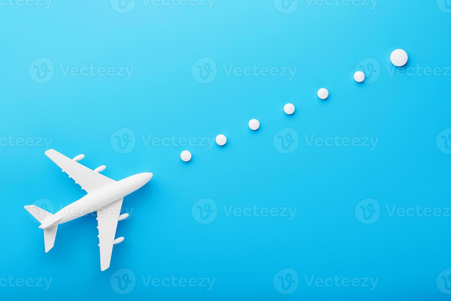 White model of a passenger plane with dotted trajectory points isolated on background. The route of the aircraft in the countries and the sky. photo