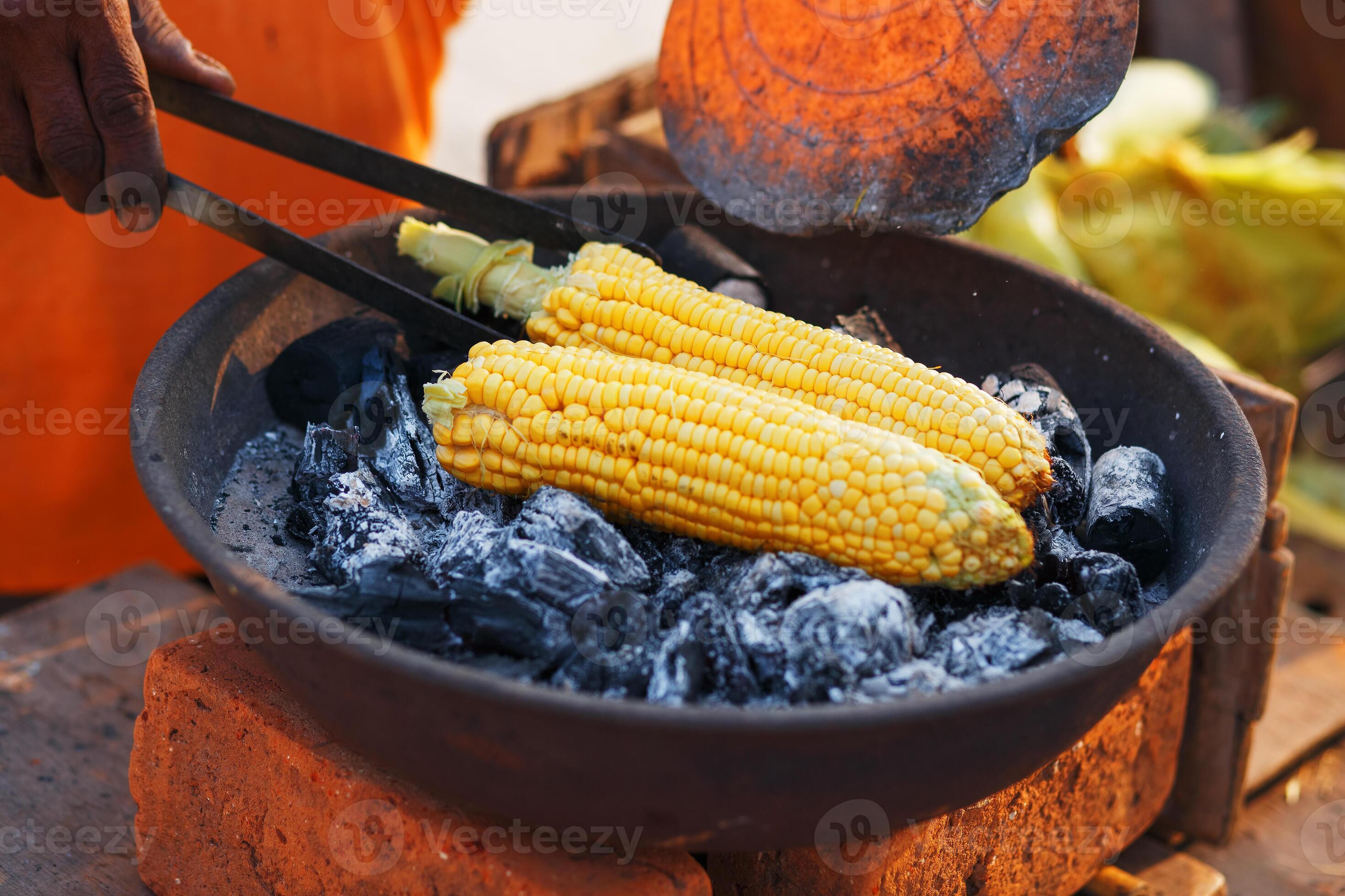 Indian Food On The Beach Fresh Corn Cobs Are Roasted On The Coals indian-food-on-the-beach-fresh-corn-cobs-are-roasted-on-the-coals