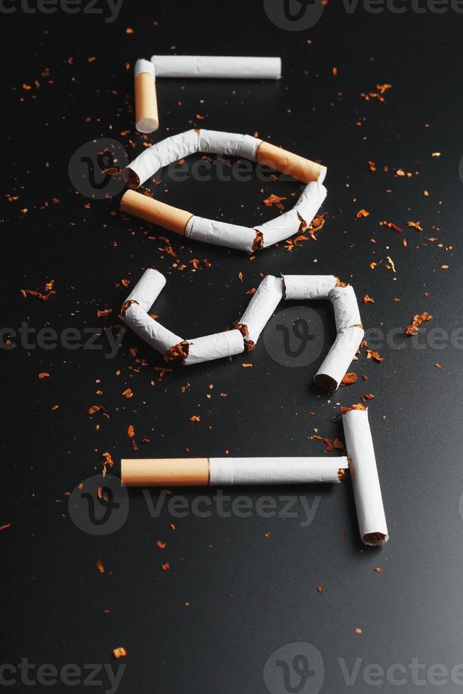 The inscription LOST from cigarettes on a black background. Stop smoking. The concept of smoking kills. Motivation inscription to quit smoking, unhealthy habit. photo