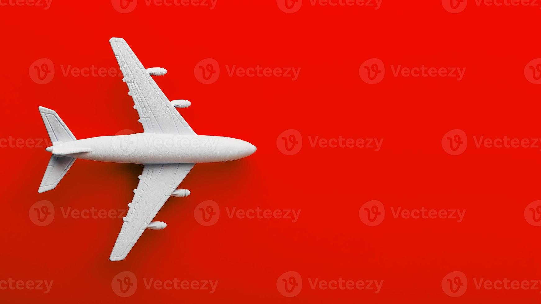 White passenger model airplane on a bright red background. Free space for text photo