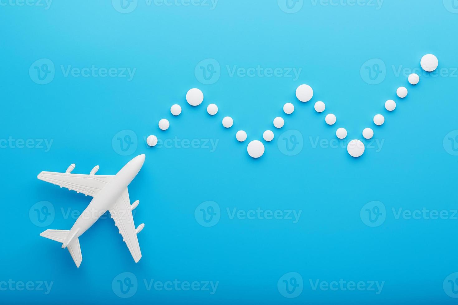 modelo blanco de un avión de pasajeros con puntos de trayectoria punteados aislados en el fondo. la ruta de la aeronave en los países y el cielo. foto