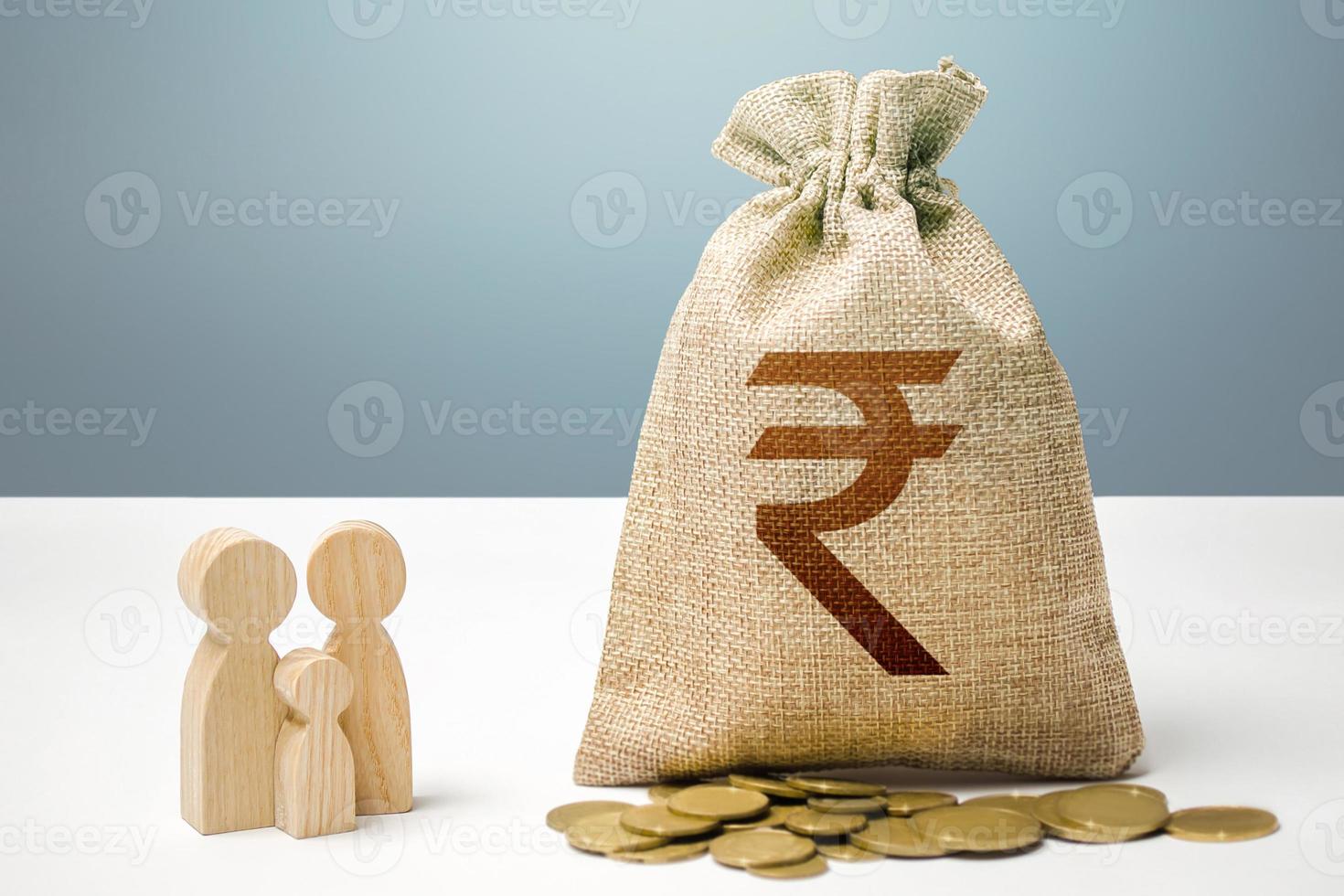 Indian rupee money bag with money and family figurines. Financial support for social institutions. Providing assistance to citizens. Investments in human capital, culture and social projects. photo