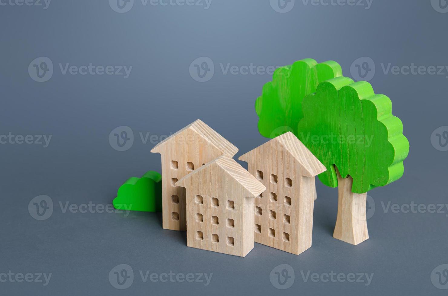 Residential buildings among the trees. Environmentally friendly, energy efficiency, zero carbon emissions. Buying and selling real estate. Renting housing, realtor services. Carbon neutrality. photo