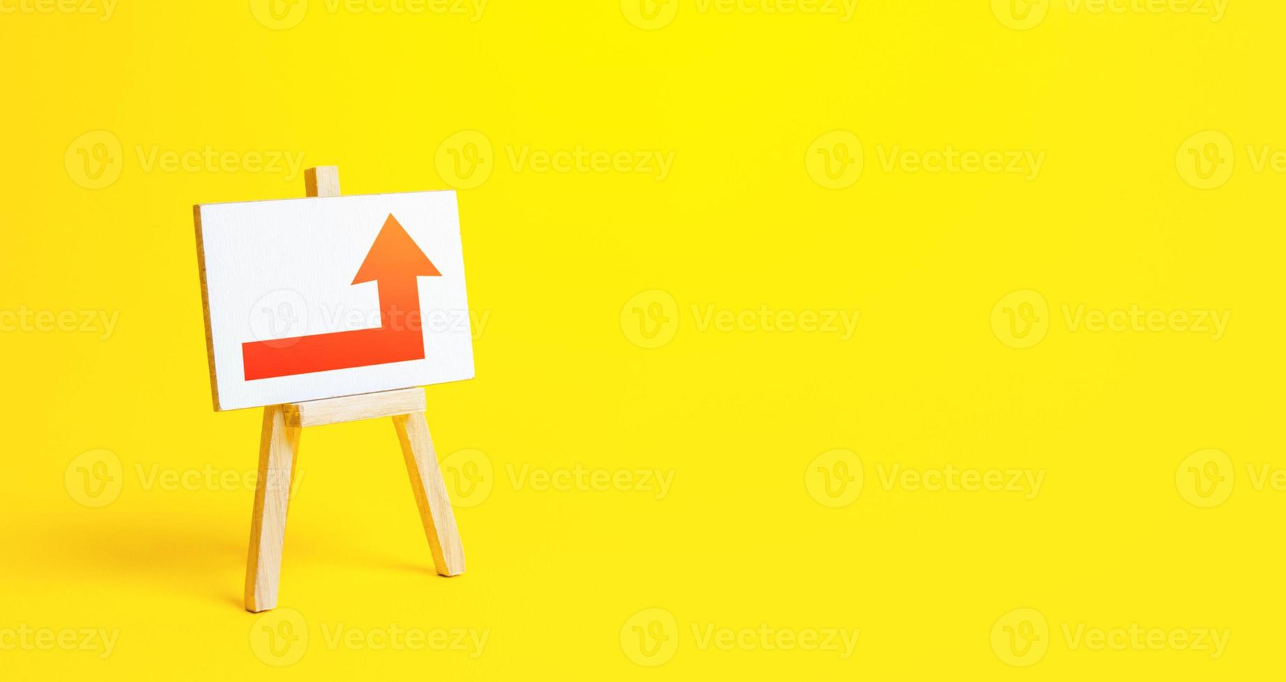 Easel with a red right up arrow. Direction to go around. Bypassing obstacles and solving problems. Alternative way. Attract attention. Advertising sign, marketing. Change of route. Copy space photo