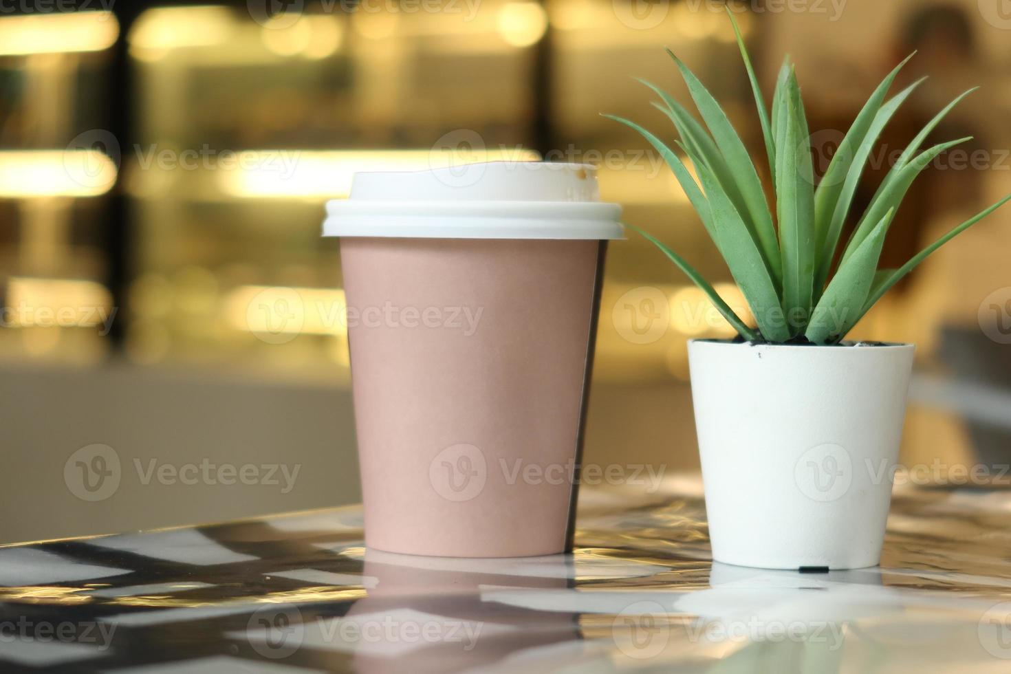 take away paper coffee cup o on cafe table photo