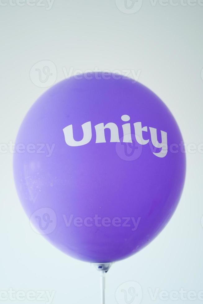 unity text on a purple color ballon, photo