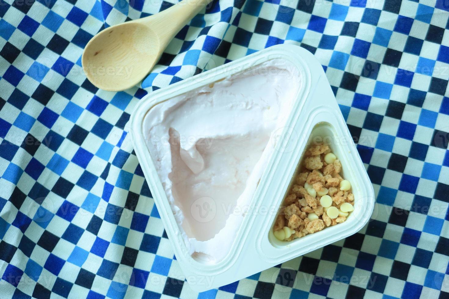 yogurt in granola Musli in a plastic packet on table photo