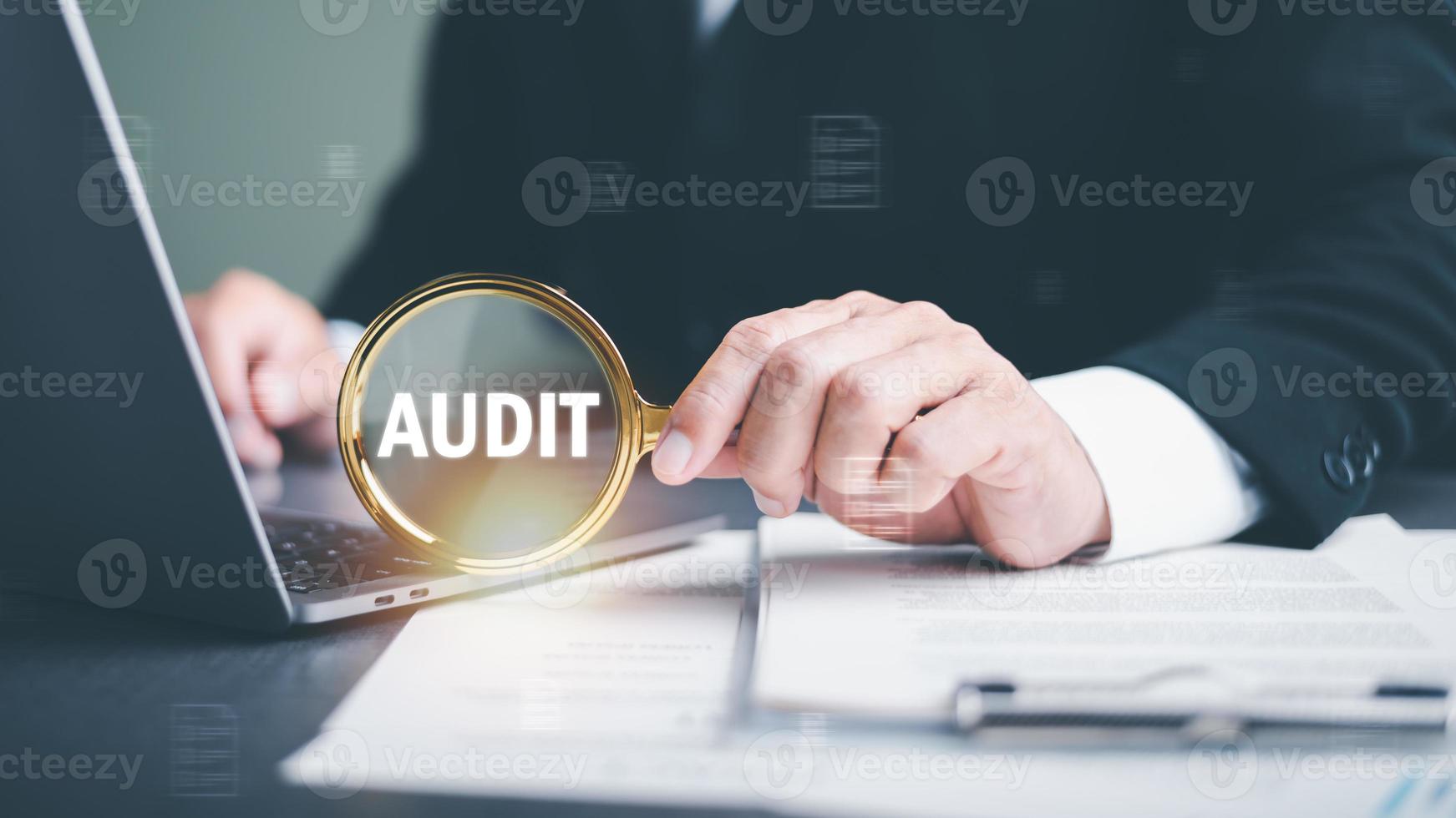 Businessman Audit documents with a magnifying glass, Quality Assessment Management with checklists, business document evaluation processes, market data report analysis and consulting photo