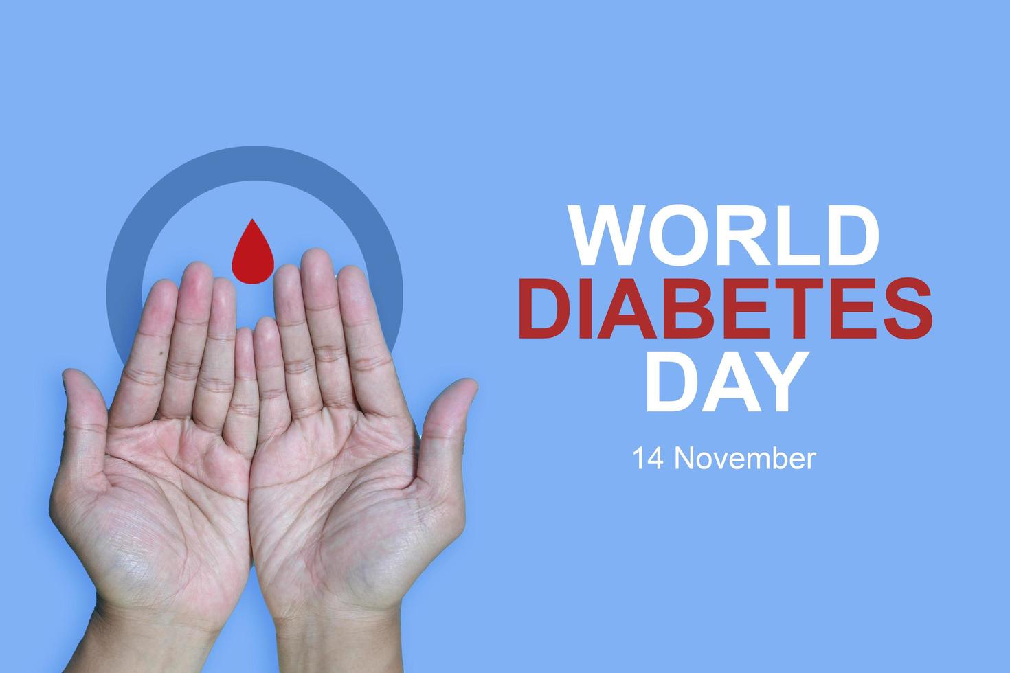 Top view inscription world diabetes day and hand gesture with red blood drop in man hands isolated on a blue background. World diabetes day, 14 november. Copy space, Health Awareness photo